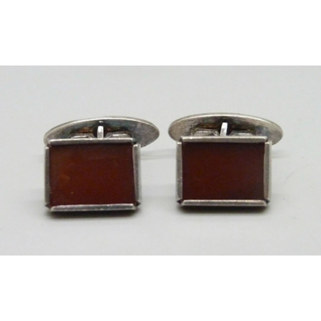 A pair of circa 1970s silver and carnelian Modernist cufflin...