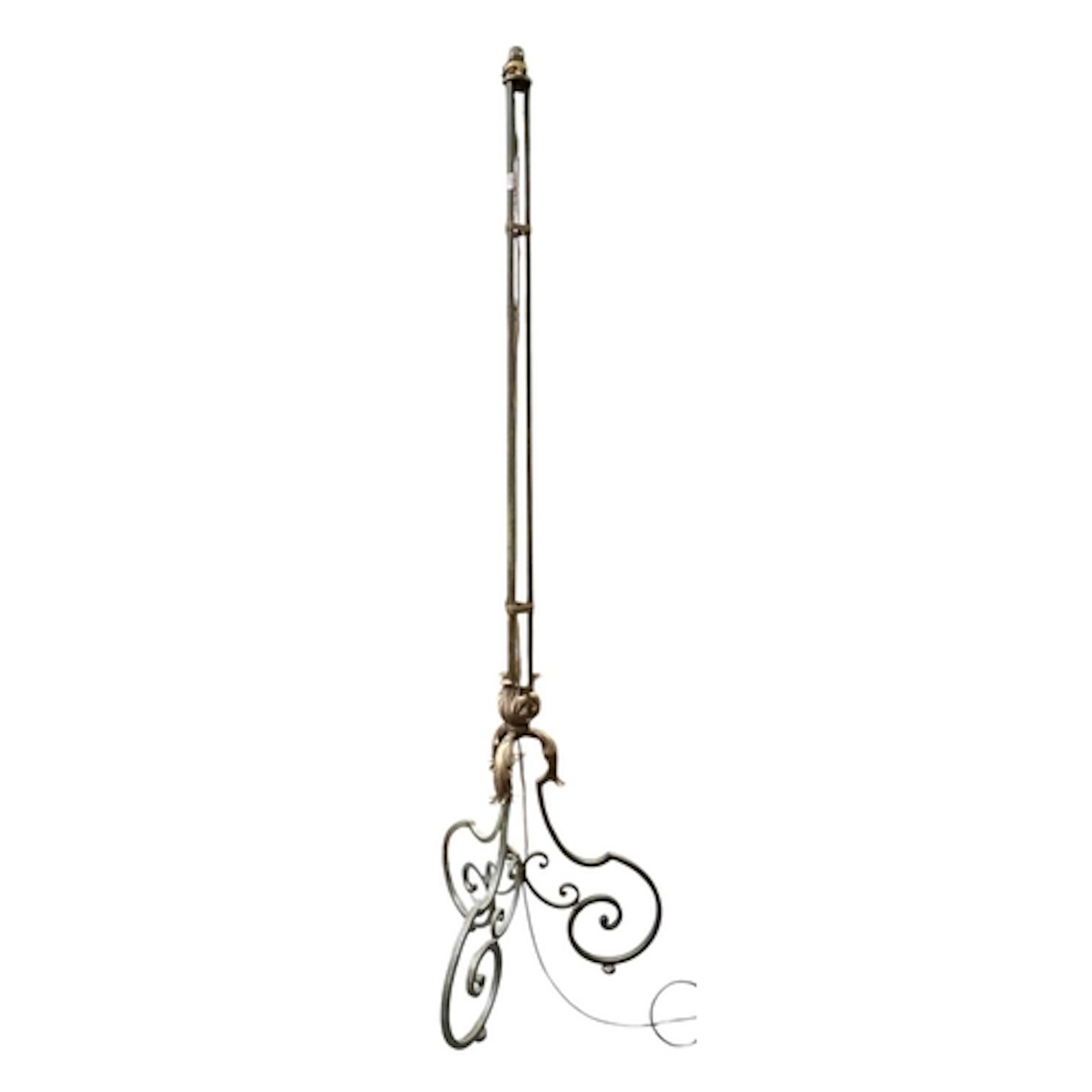 A rustic 20th century wrought-iron floor-standing lamp light...