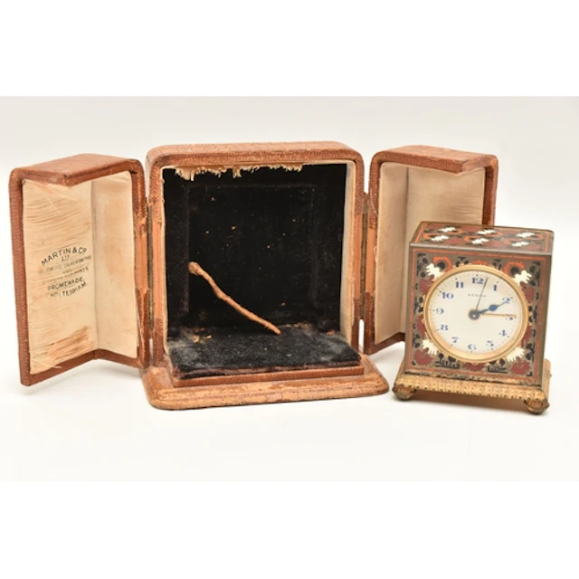 A CASED 'ZENITH' MINIATURE TRAVEL ALARM CLOCK, decorated wit...