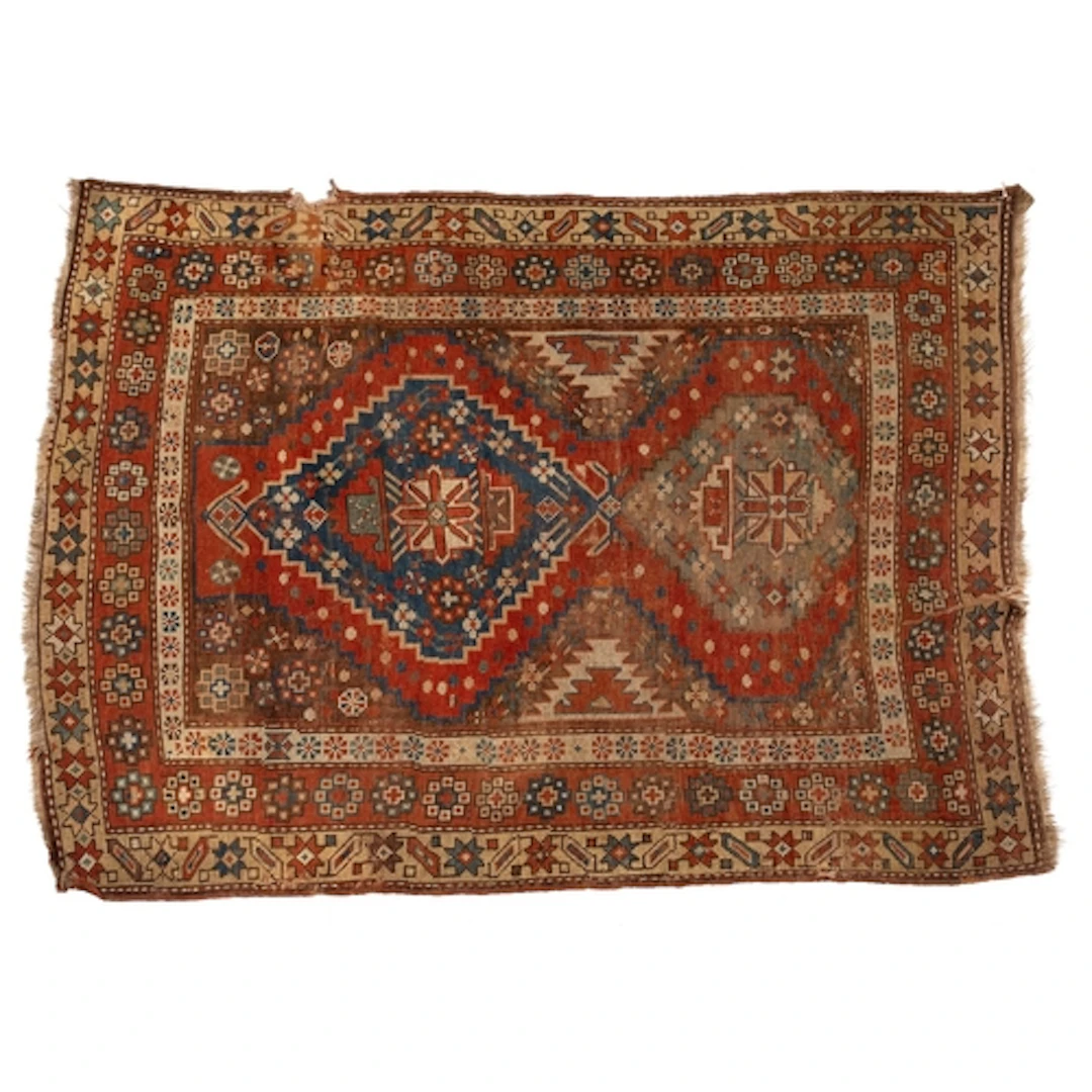 A Caucasian rug, the rust field with stepped and pointed med...