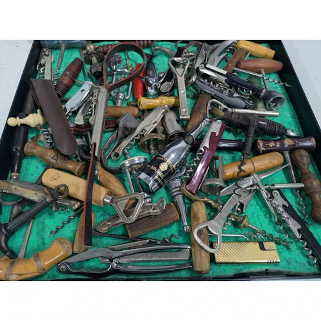 A collection of vintage cork screws and bottle openers to in...