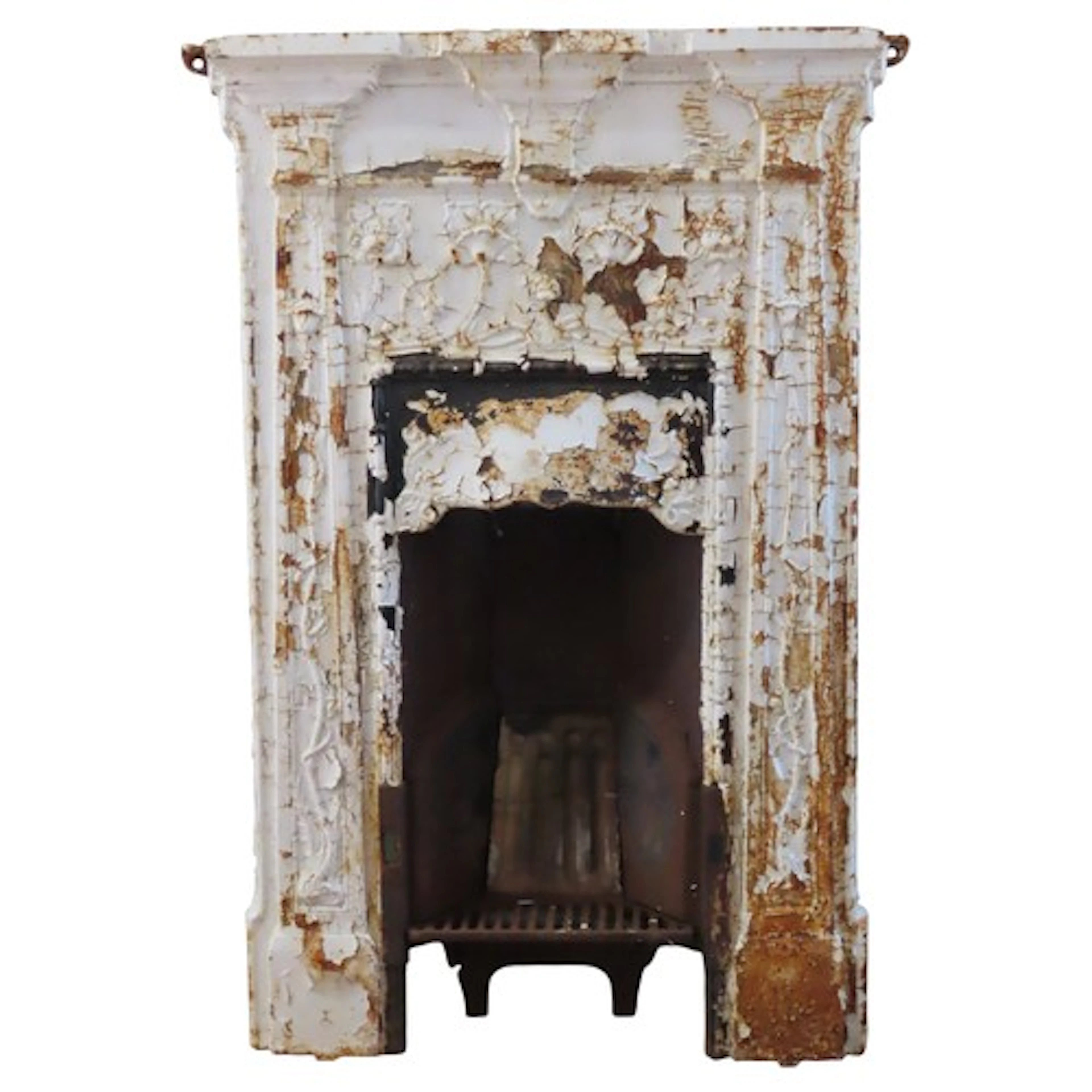 A Victorian cast iron fireplace with white-painted finish, a...