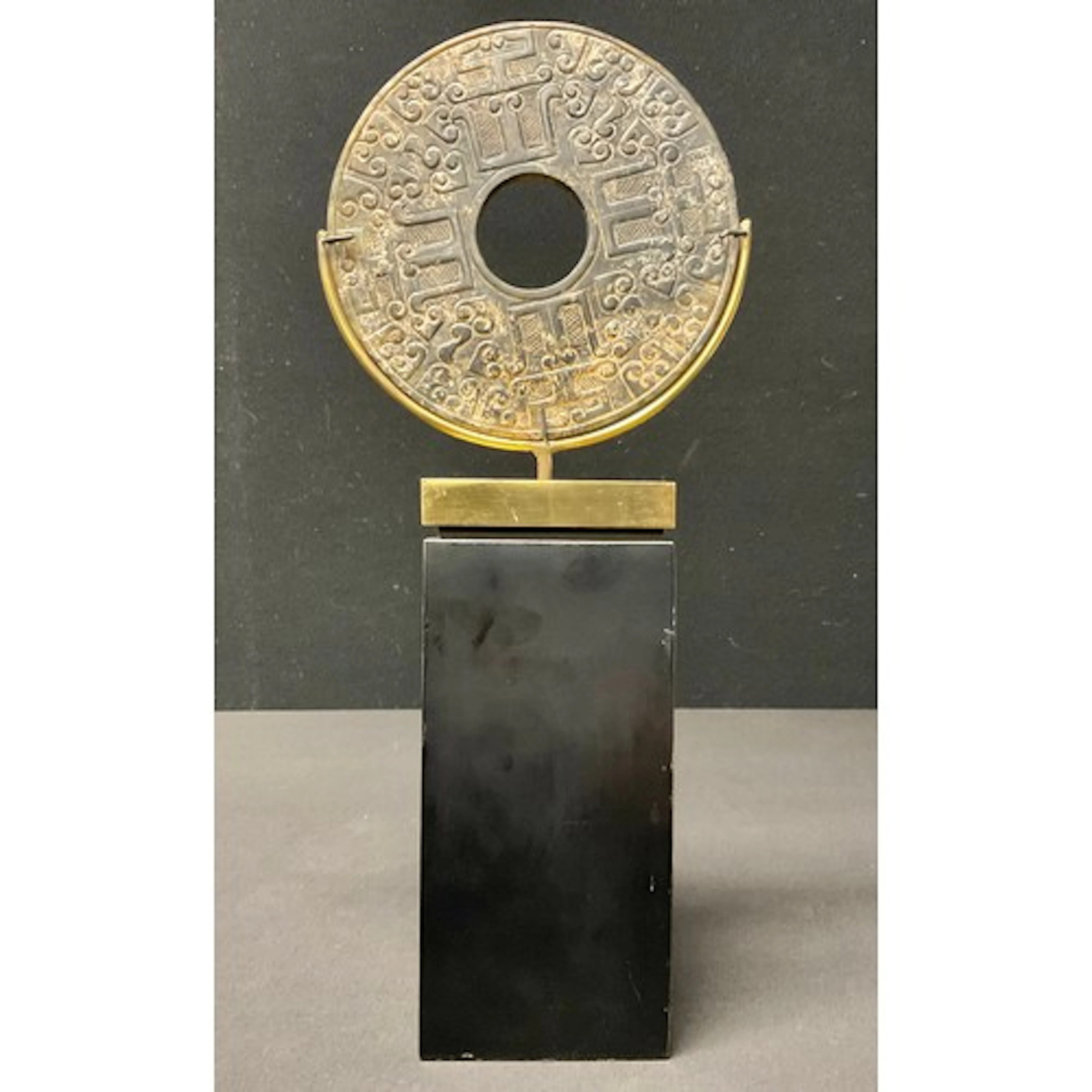 A Chinese mottled jade bi-disc on contemporary stand, bi-dis...