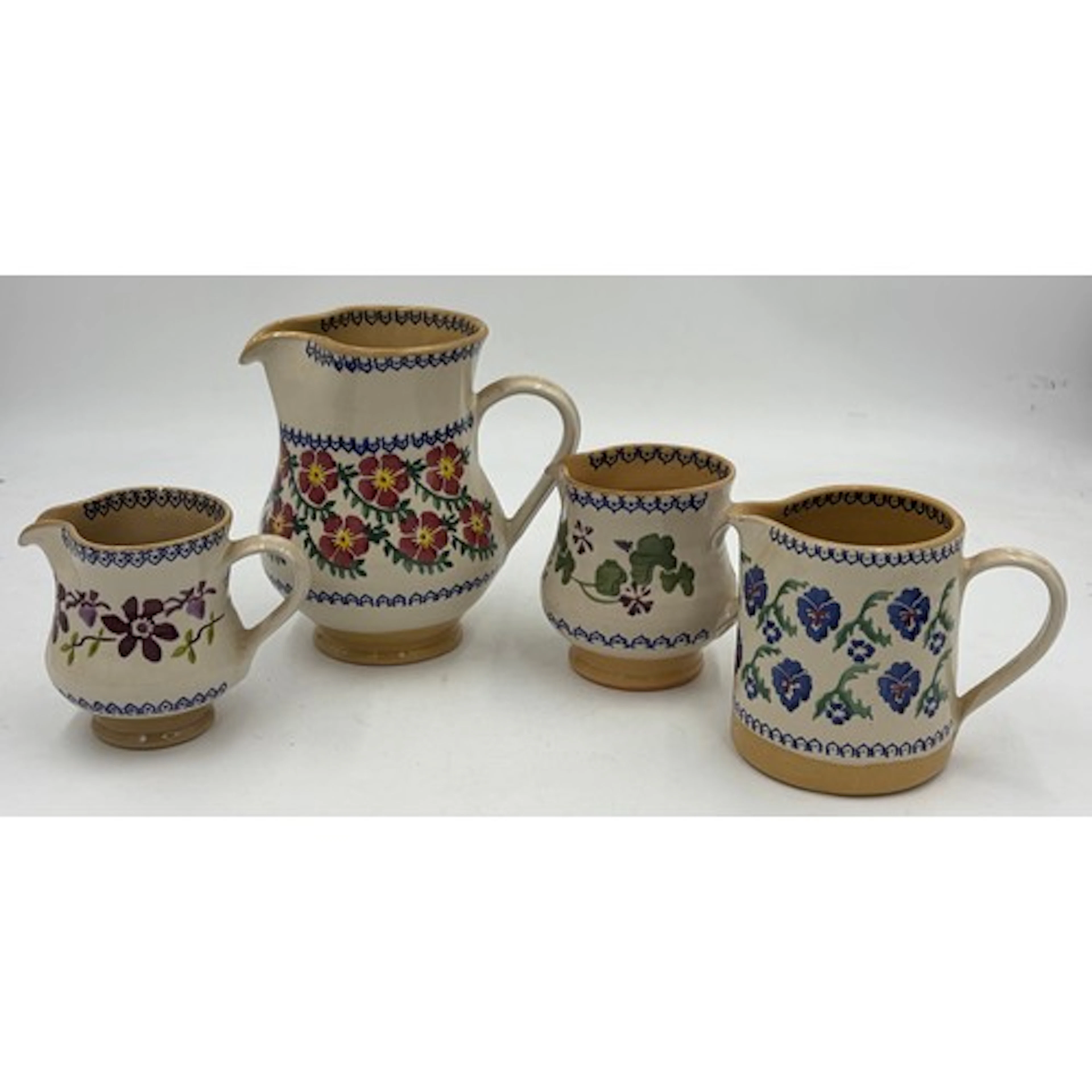 A collection of Nicholas Mosse pottery jugs, made in Ireland...