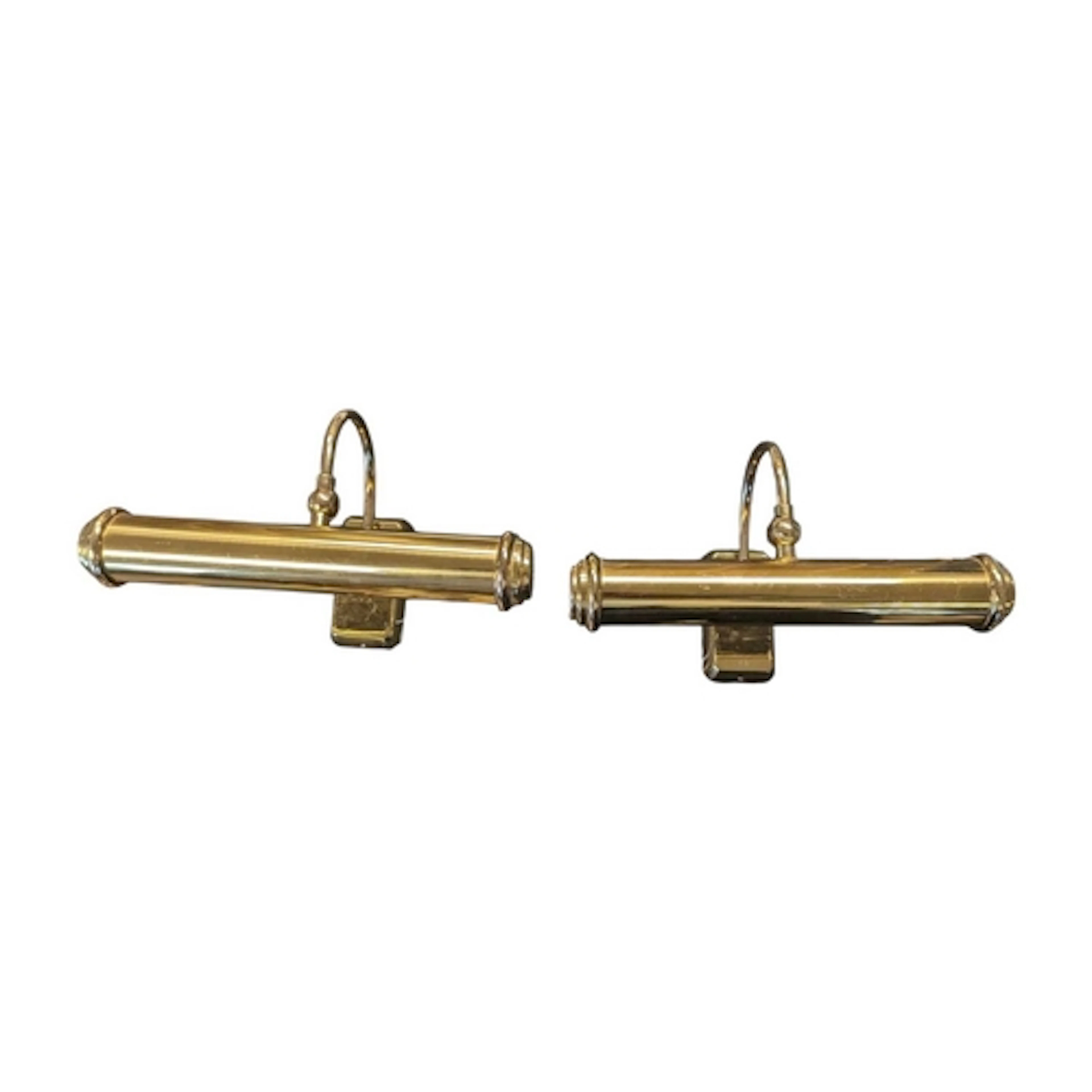 A pair of contemporary brass wall lights. Each having curved...