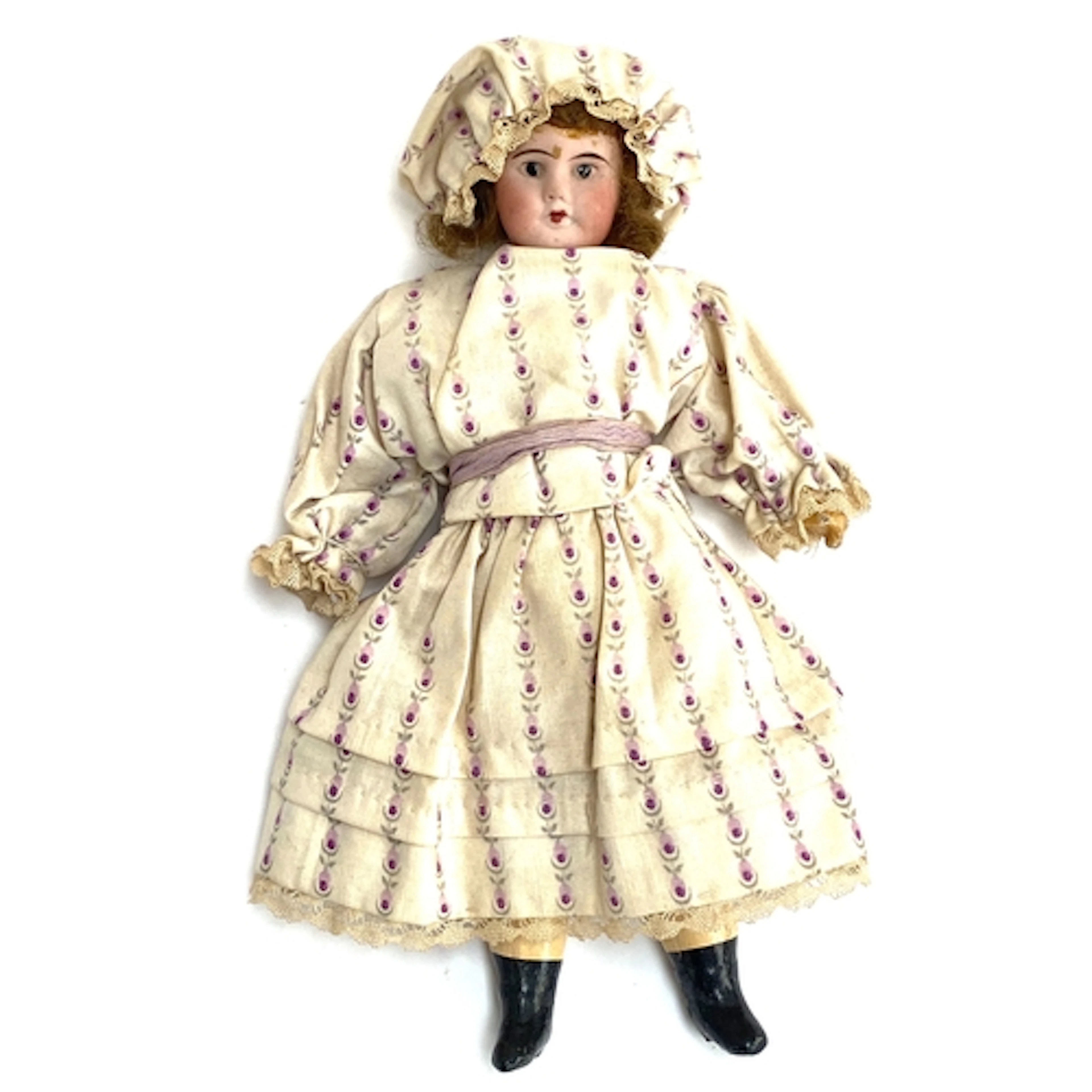 A small early 20th century French doll with bisque porcela...