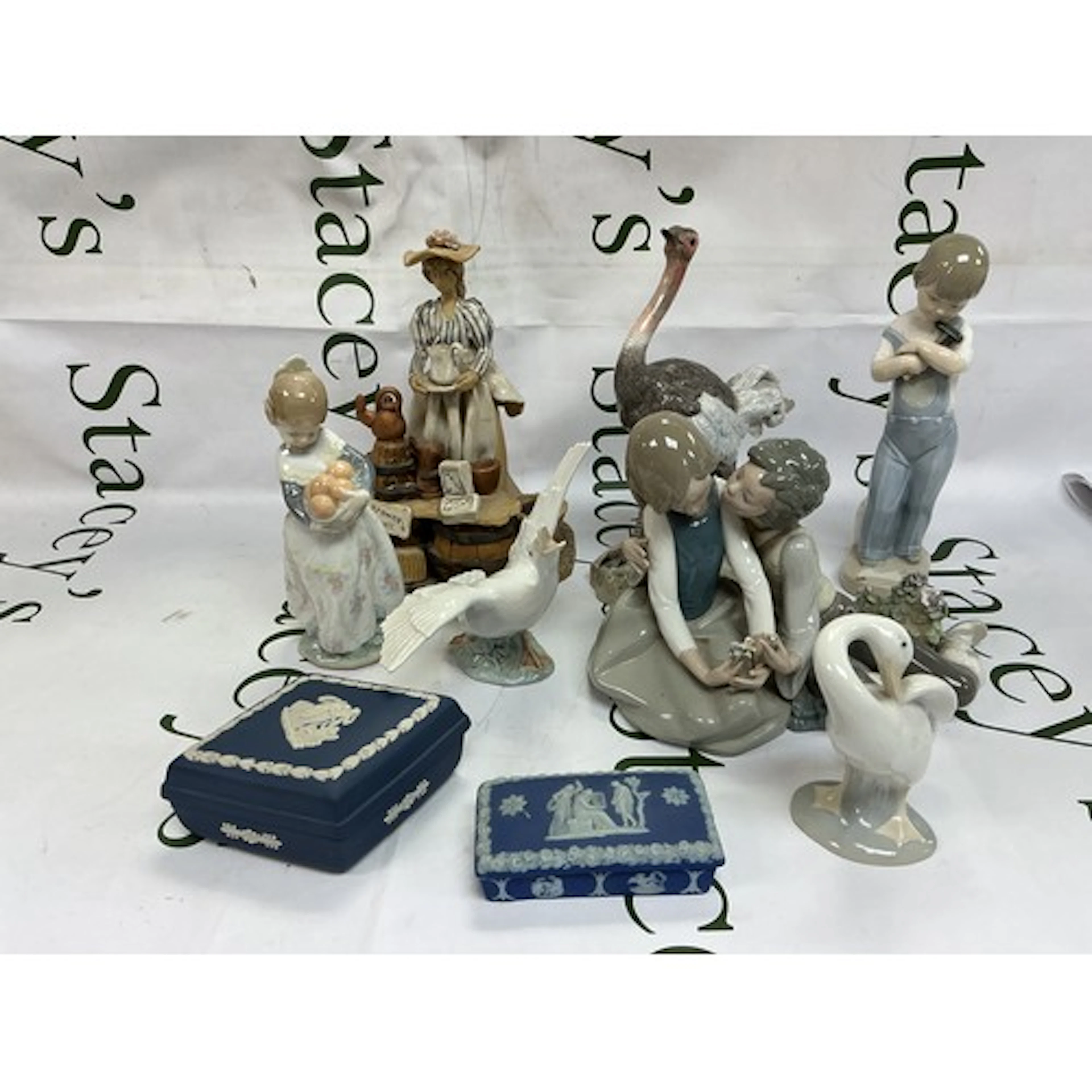 A collection of ceramic figures comprising Lladro and other ...