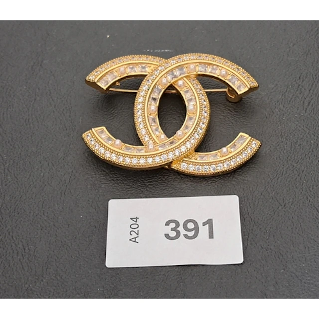 CHANEL CRYSTAL AND FAUX PEARL SET CC BROOCH in gold tone, ma...