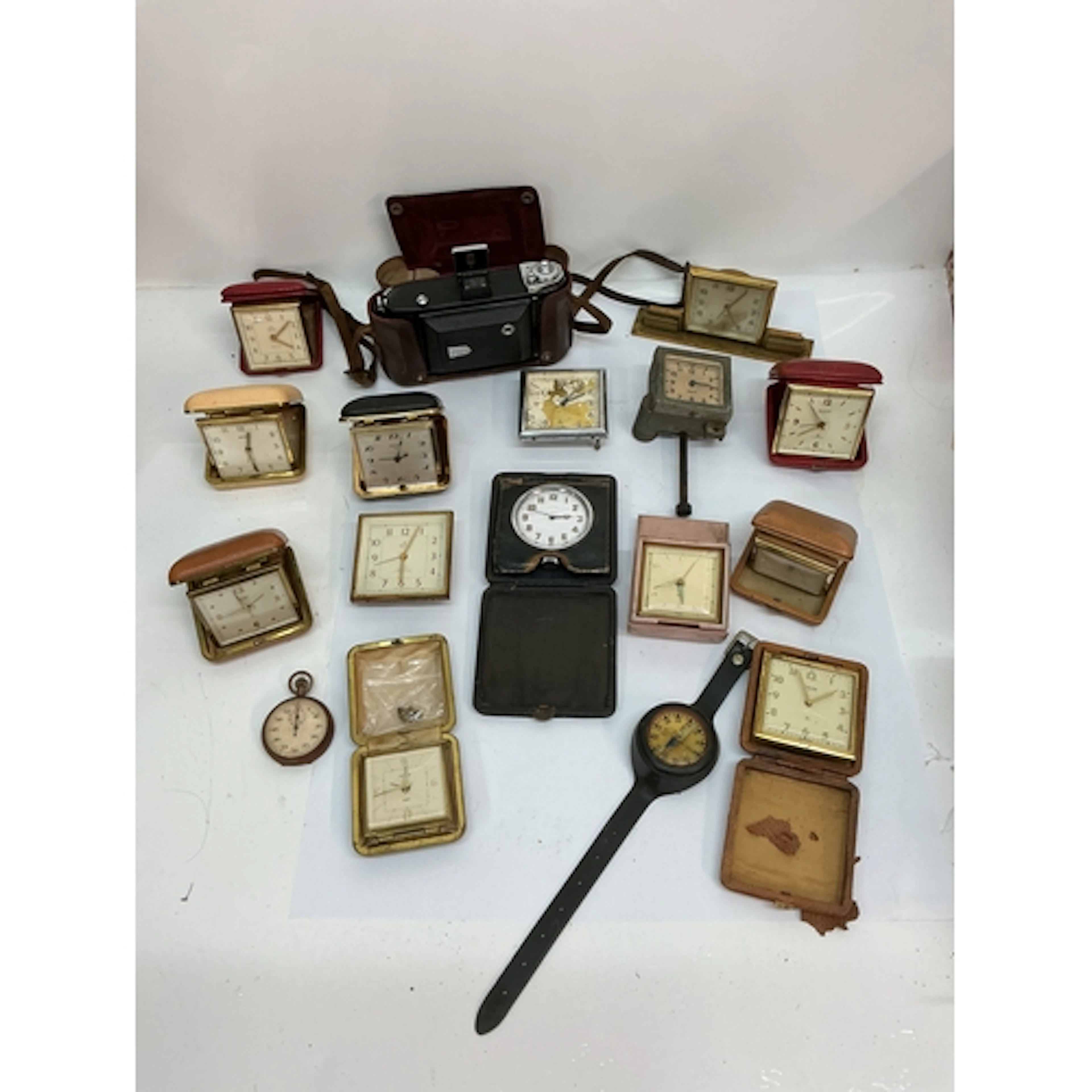 A collection of vintage travelling clocks including Swiza an...