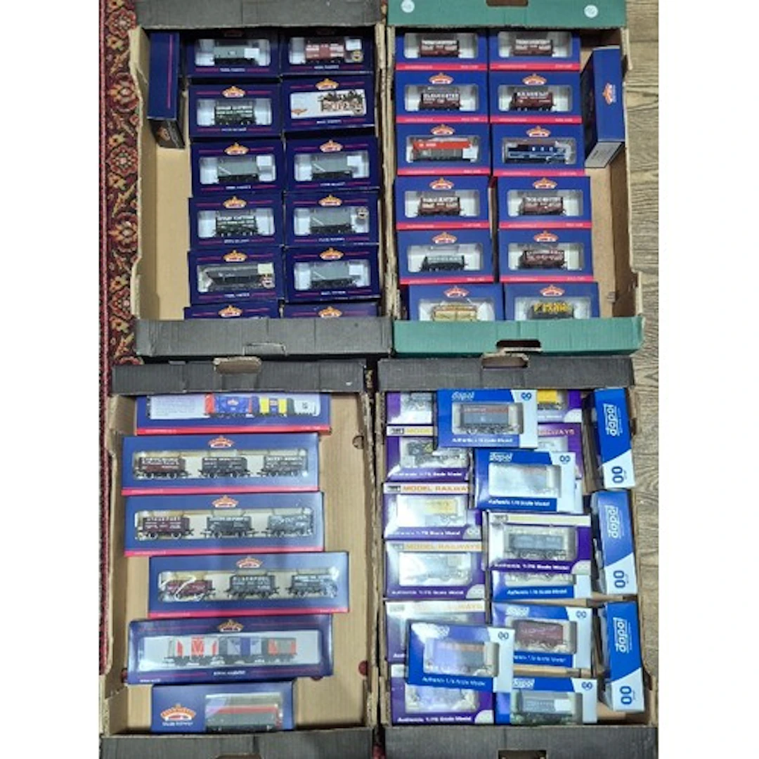 Four boxes of assorted model railway rolling stock to includ...