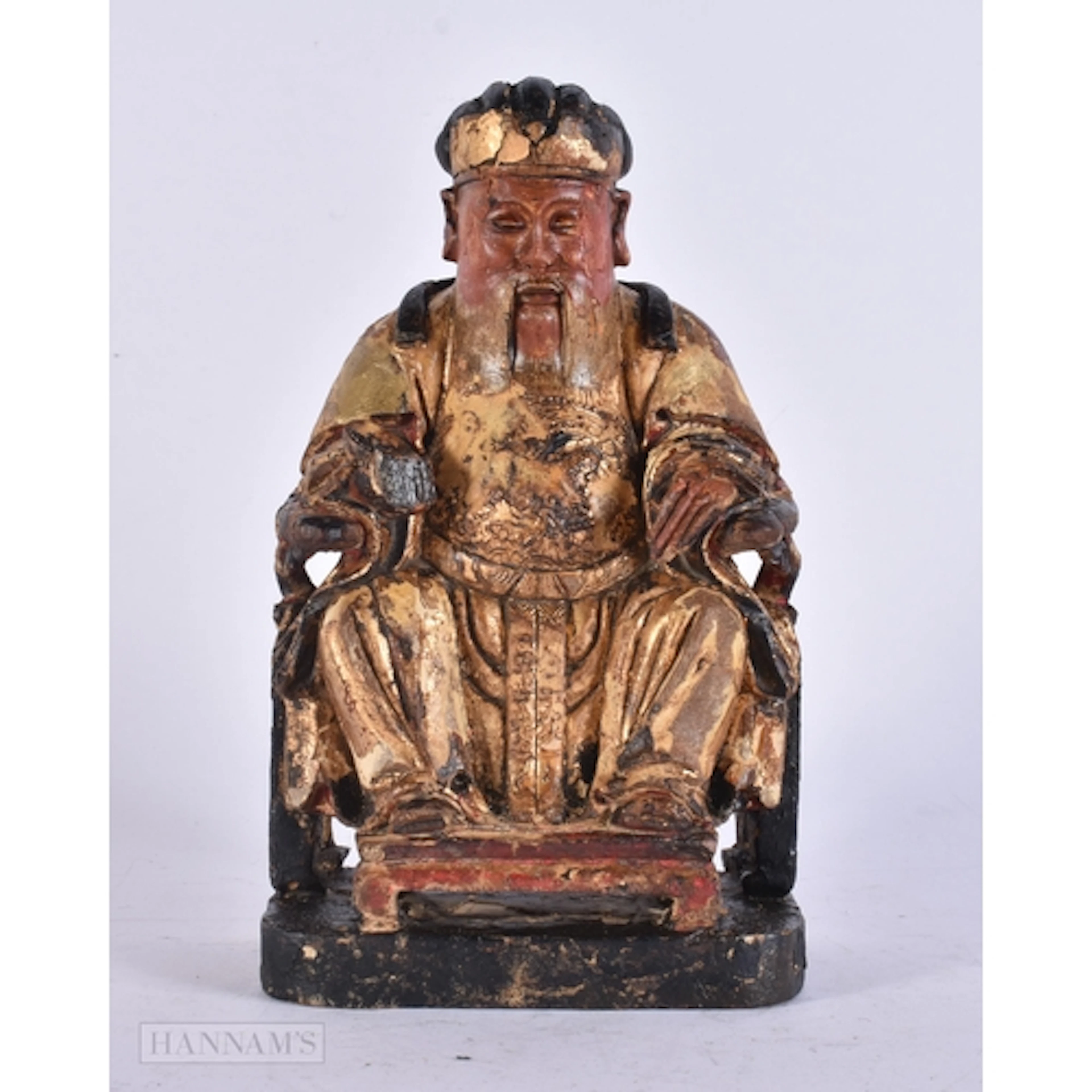A CHINESE QING DYNASTY POLYCHROMED WOOD FIGURE OF A SCHOLAR....
