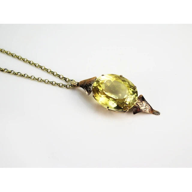 A large citrine pendant in a 9K yellow gold setting with cha...