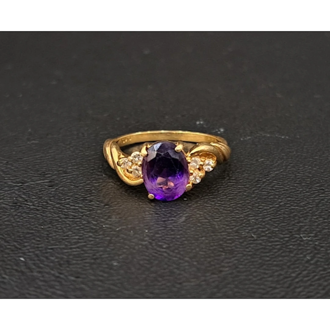 AMETHYST AND DIAMOND RING the central oval cut amethyst appr...