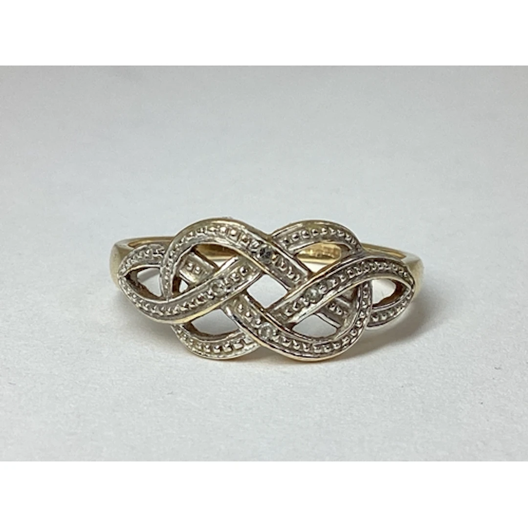 A 9ct Gold Celtic Style Knot Ring, of bi-colour openwork des...