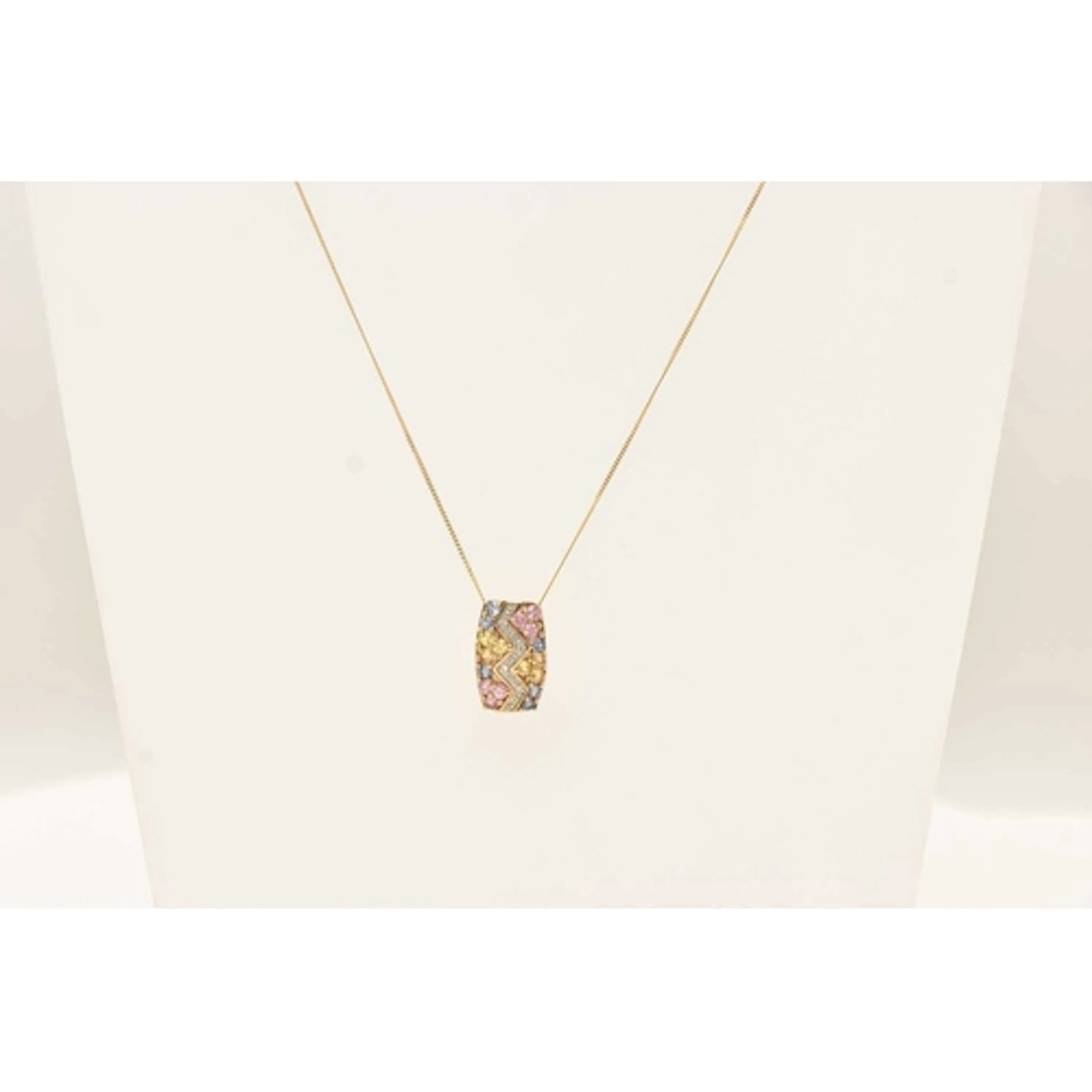 A 9CT YELLOW GOLD GEM SET PENDANT NECKLACE, a rectangular fo...