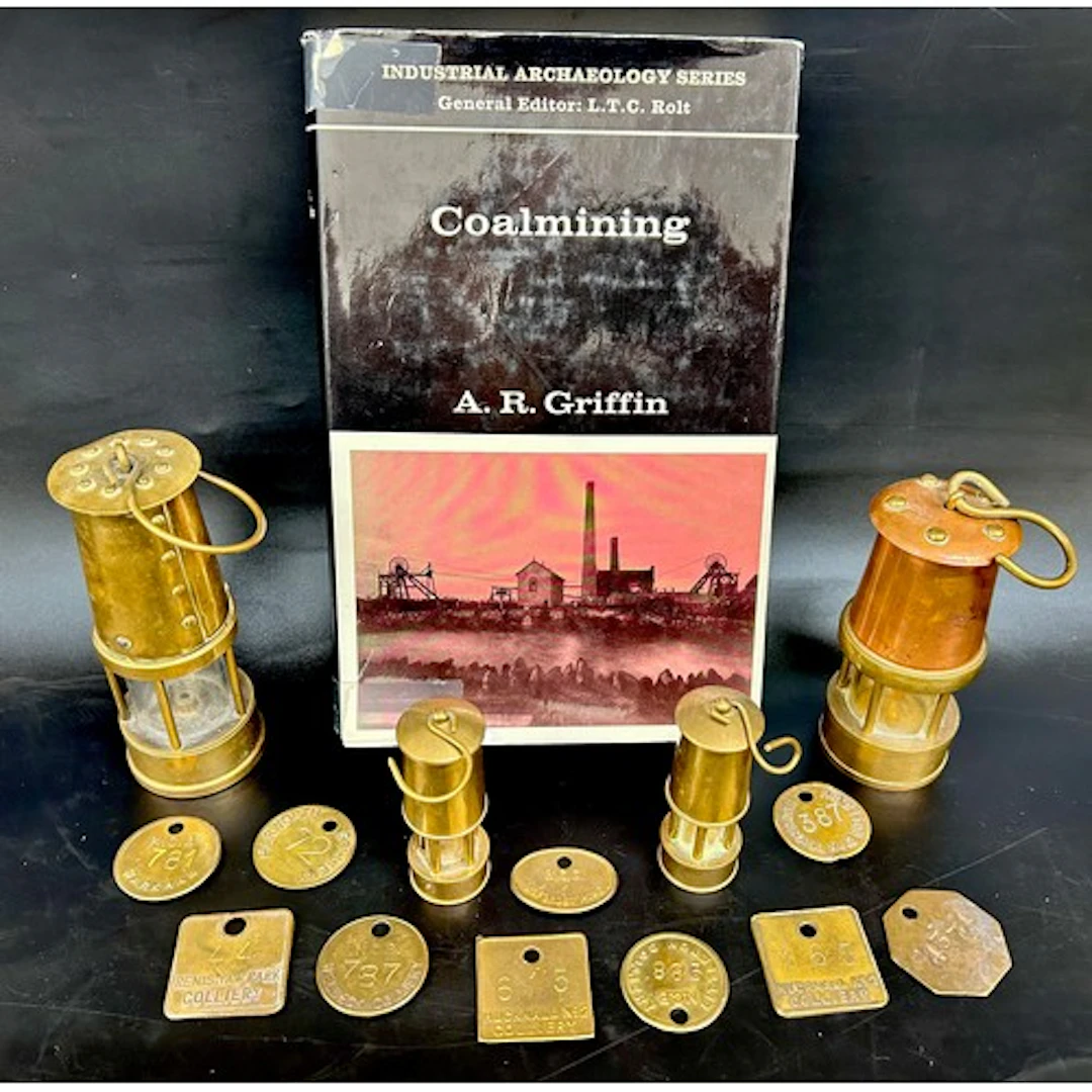 Four miniature miner's lamps, 10 pit tokens and a coal minin...