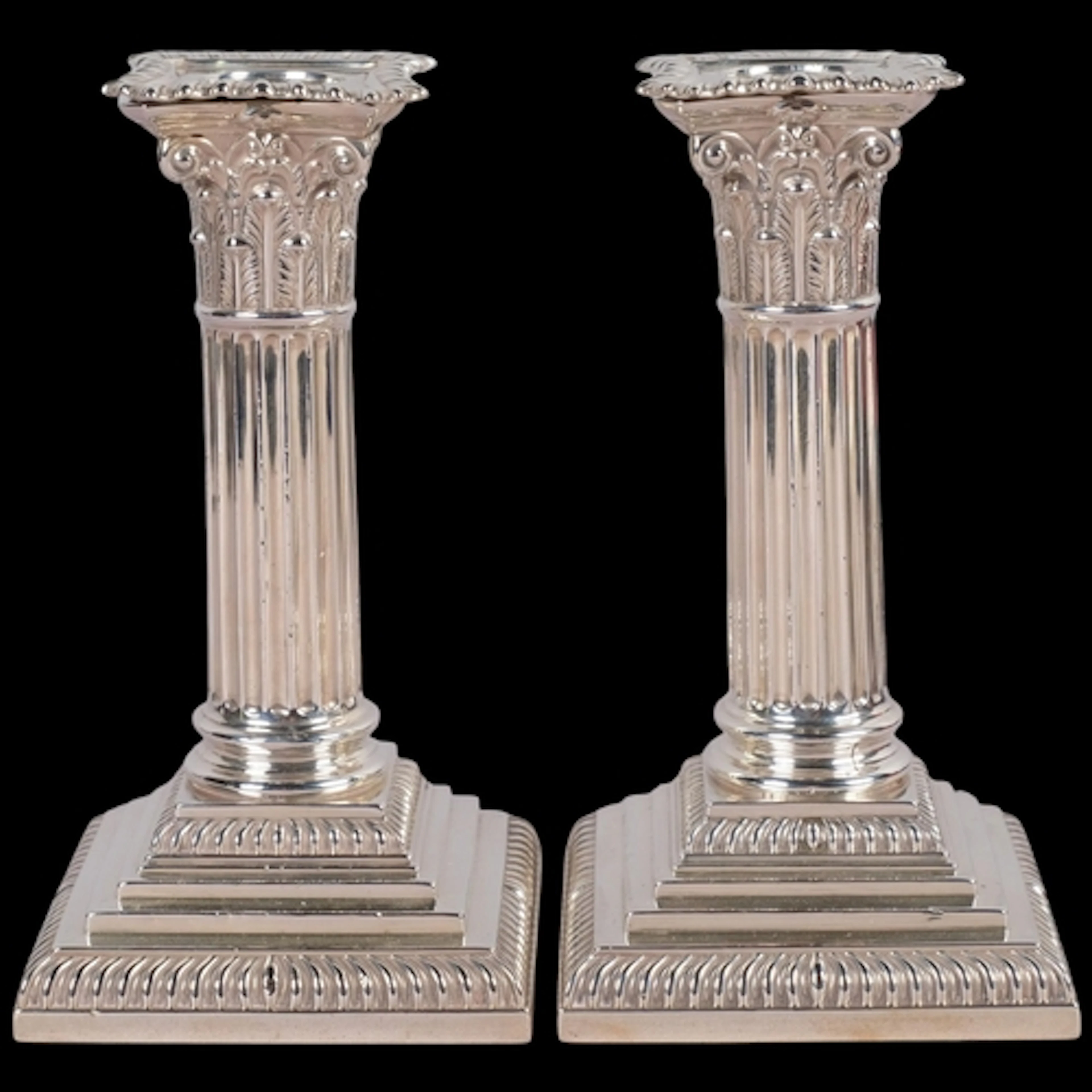 A pair of Victorian silver Corinthian column table candlesti...