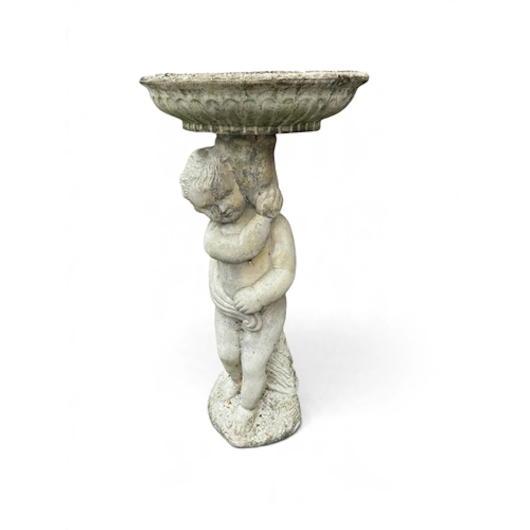 A STONE BIRD BATH IN THE FORM OF A PUTTO 75cm x 41cm...