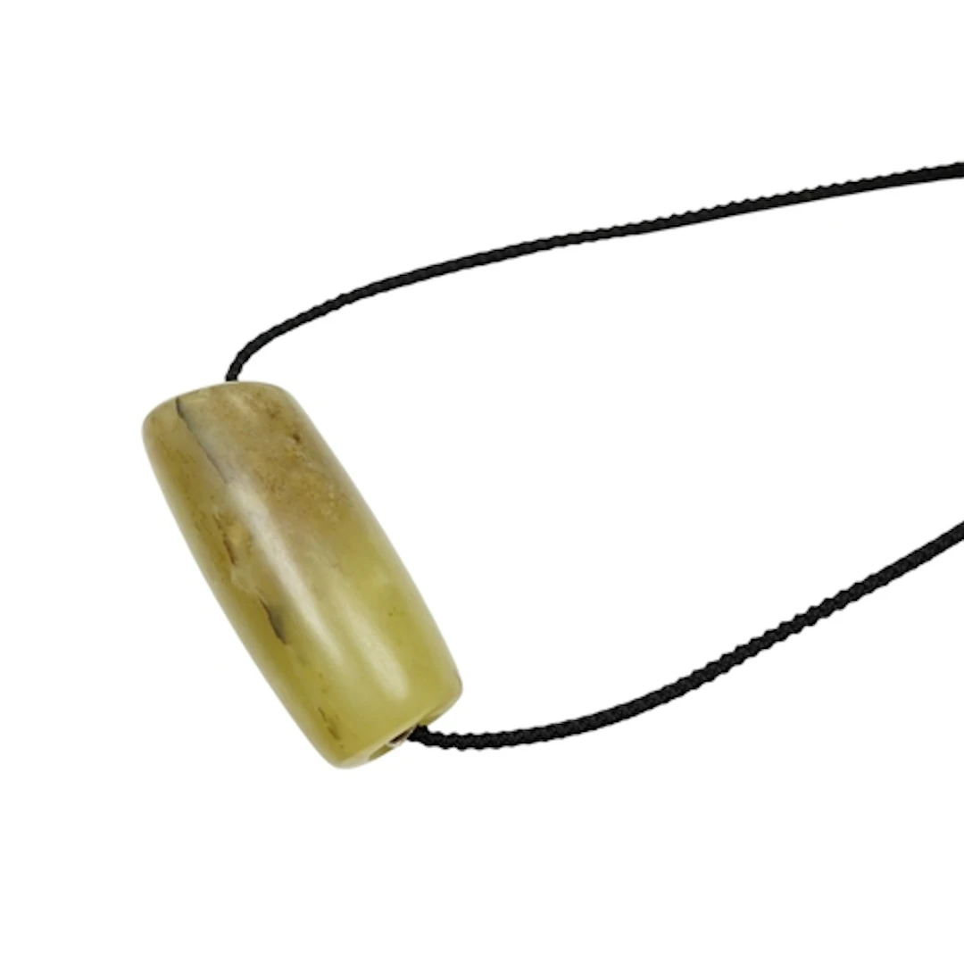 A Chinese bowenite jade cylindrical bead, length 5cm.