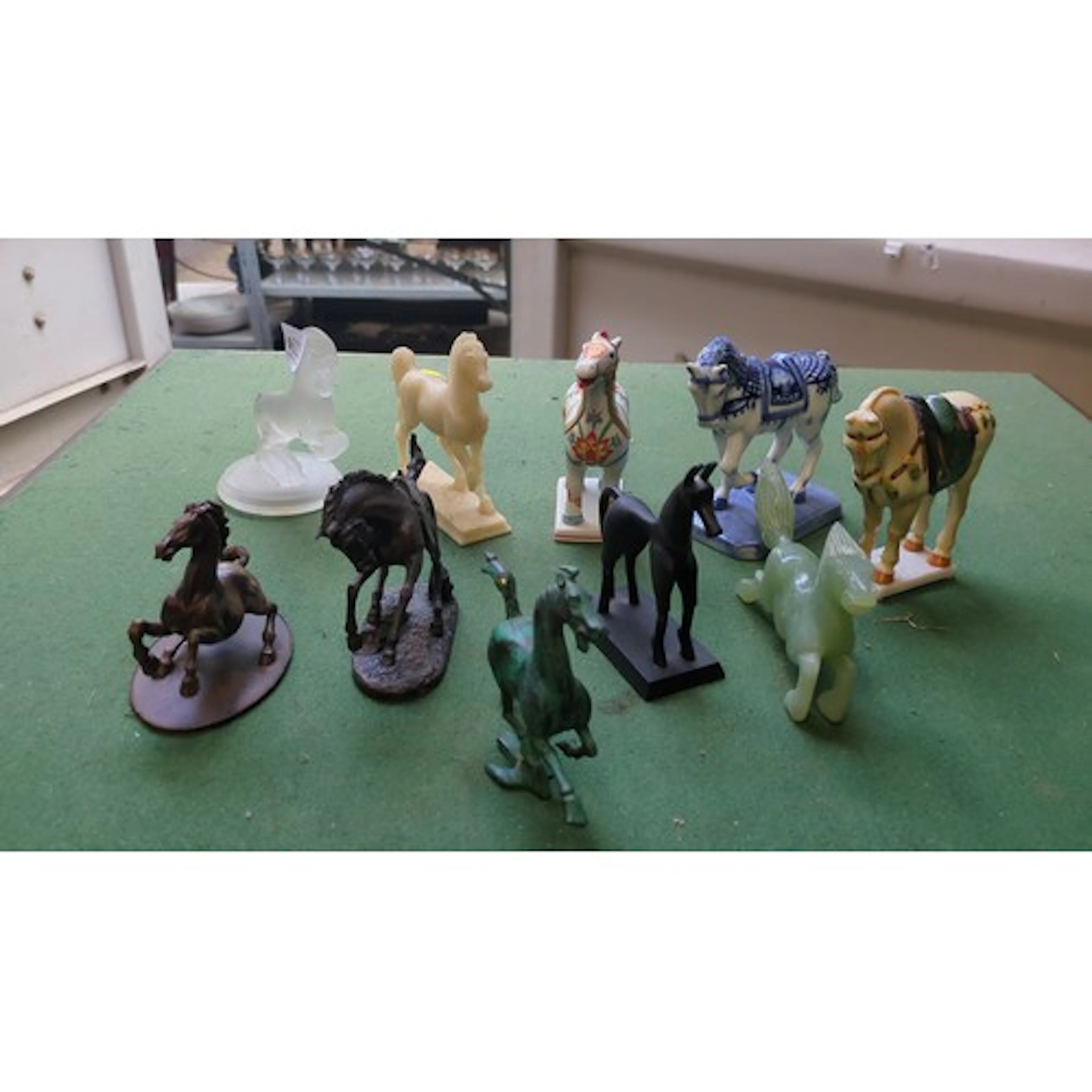 A group of decorative horse models, mixed media including gl...