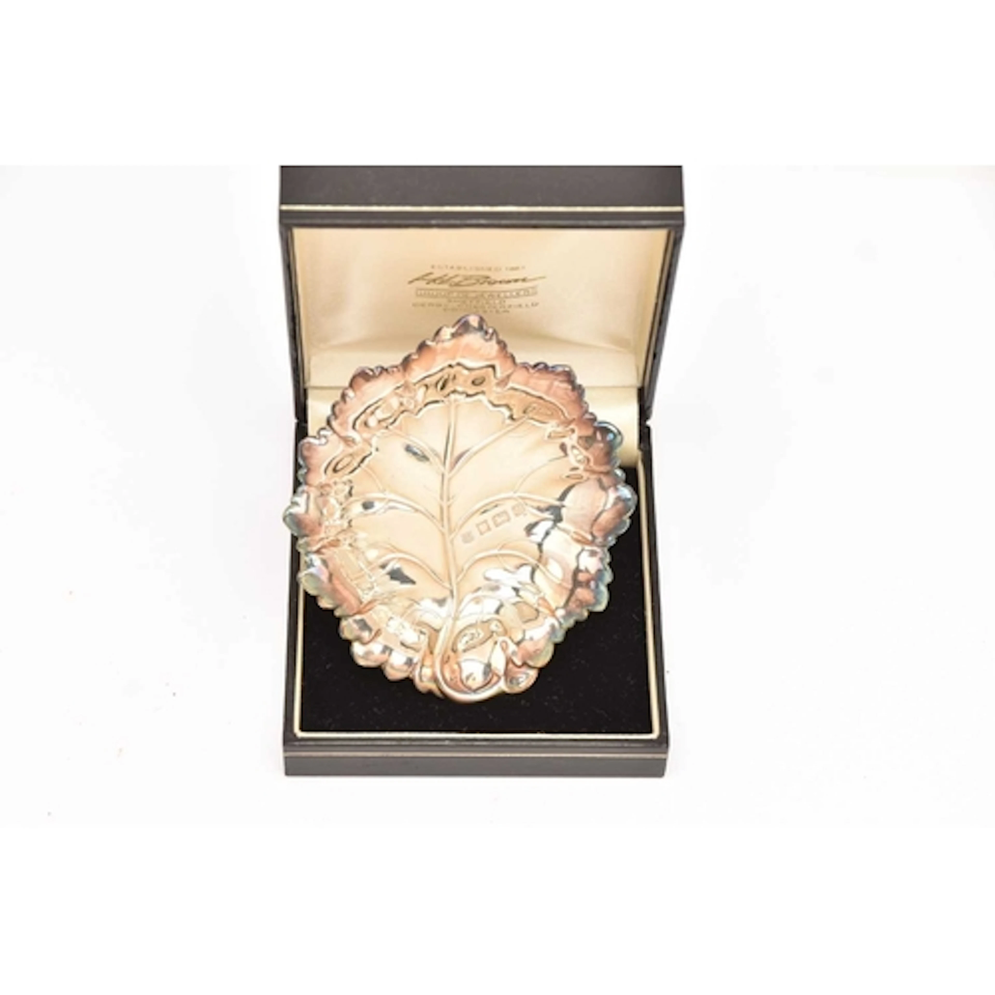 AN ELIZABETH II SILVER DISH, designed as a leaf, approximate...