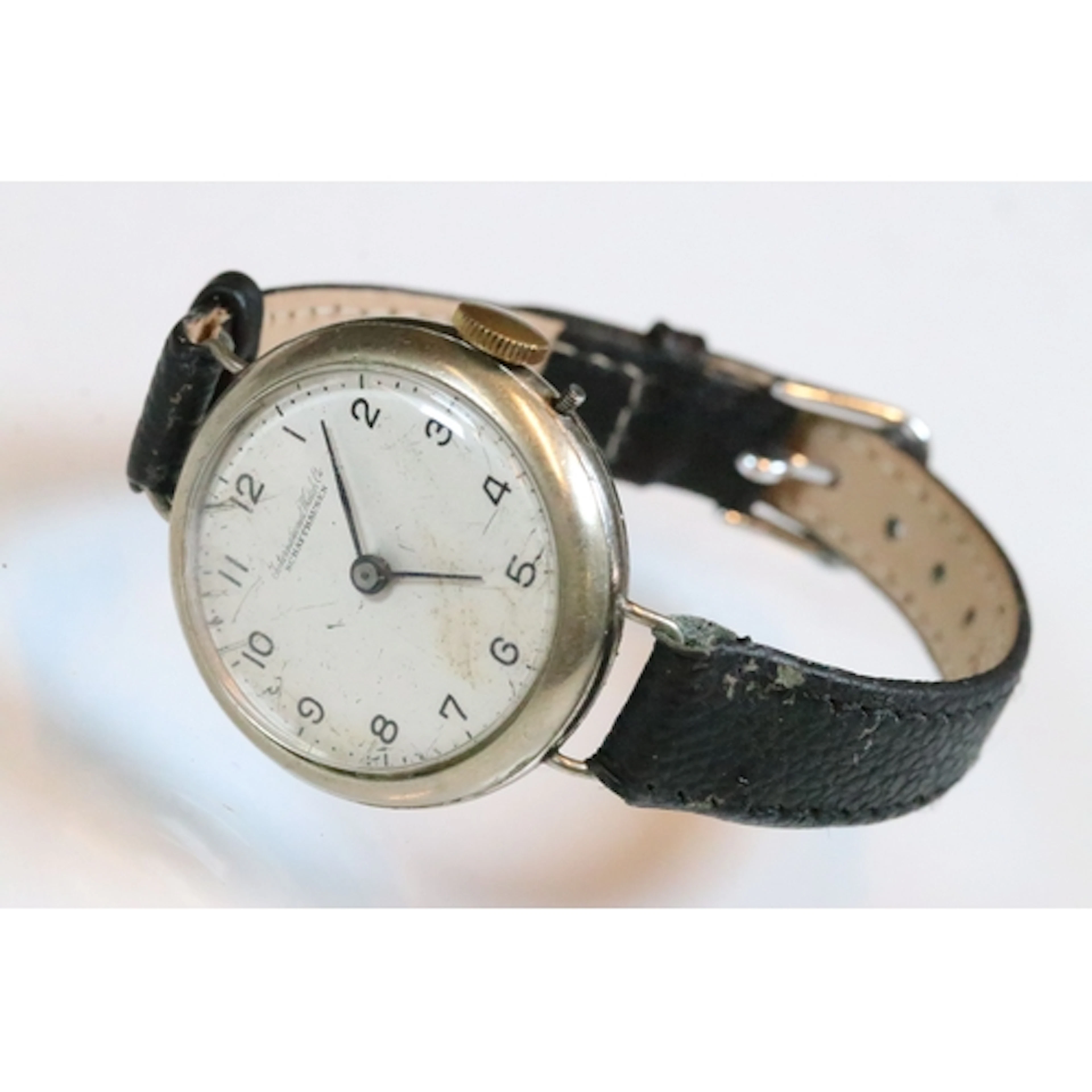 A vintage gents IWC trench style watch, mounted to black lea...