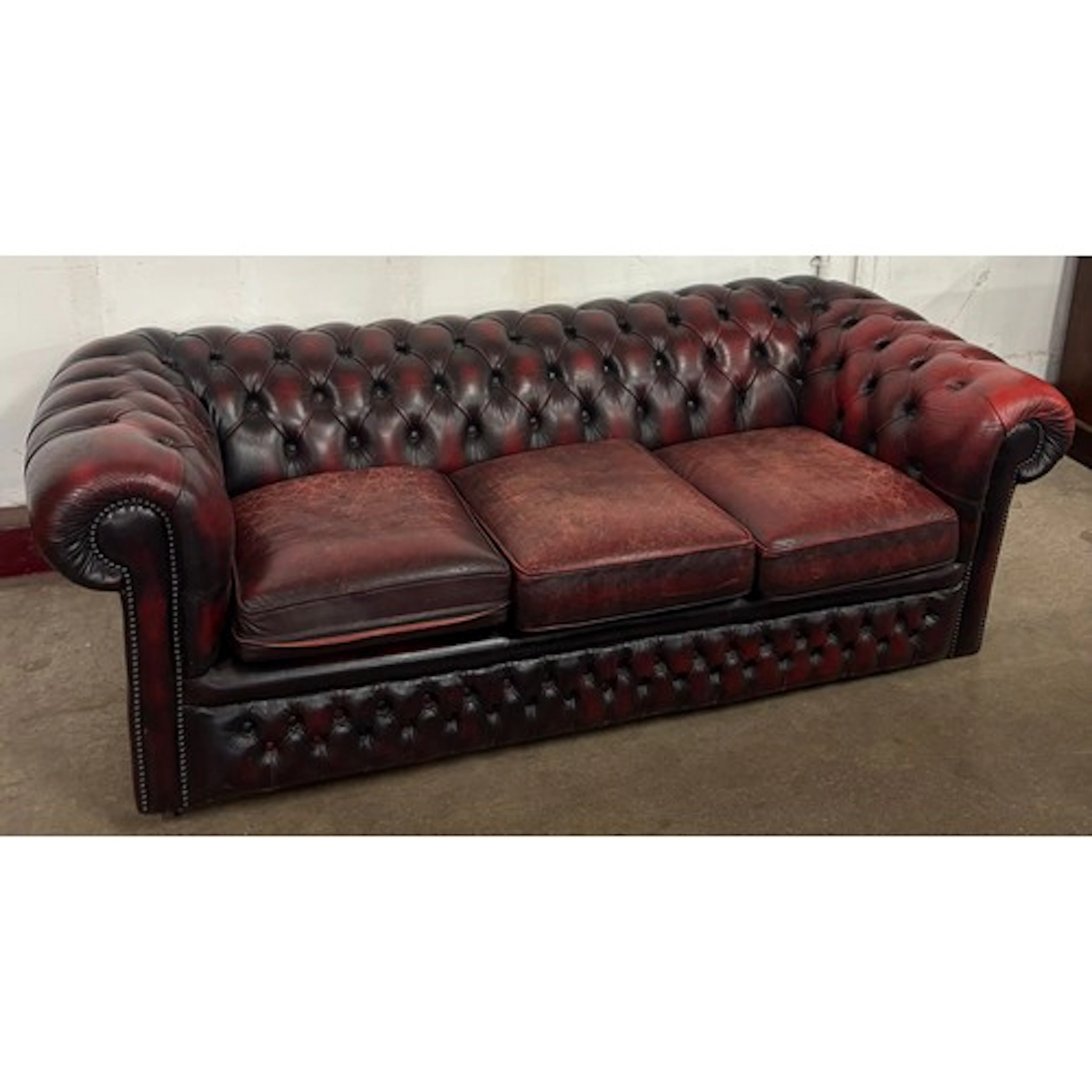 A Regency style oxblood red leather Chesterfield settee