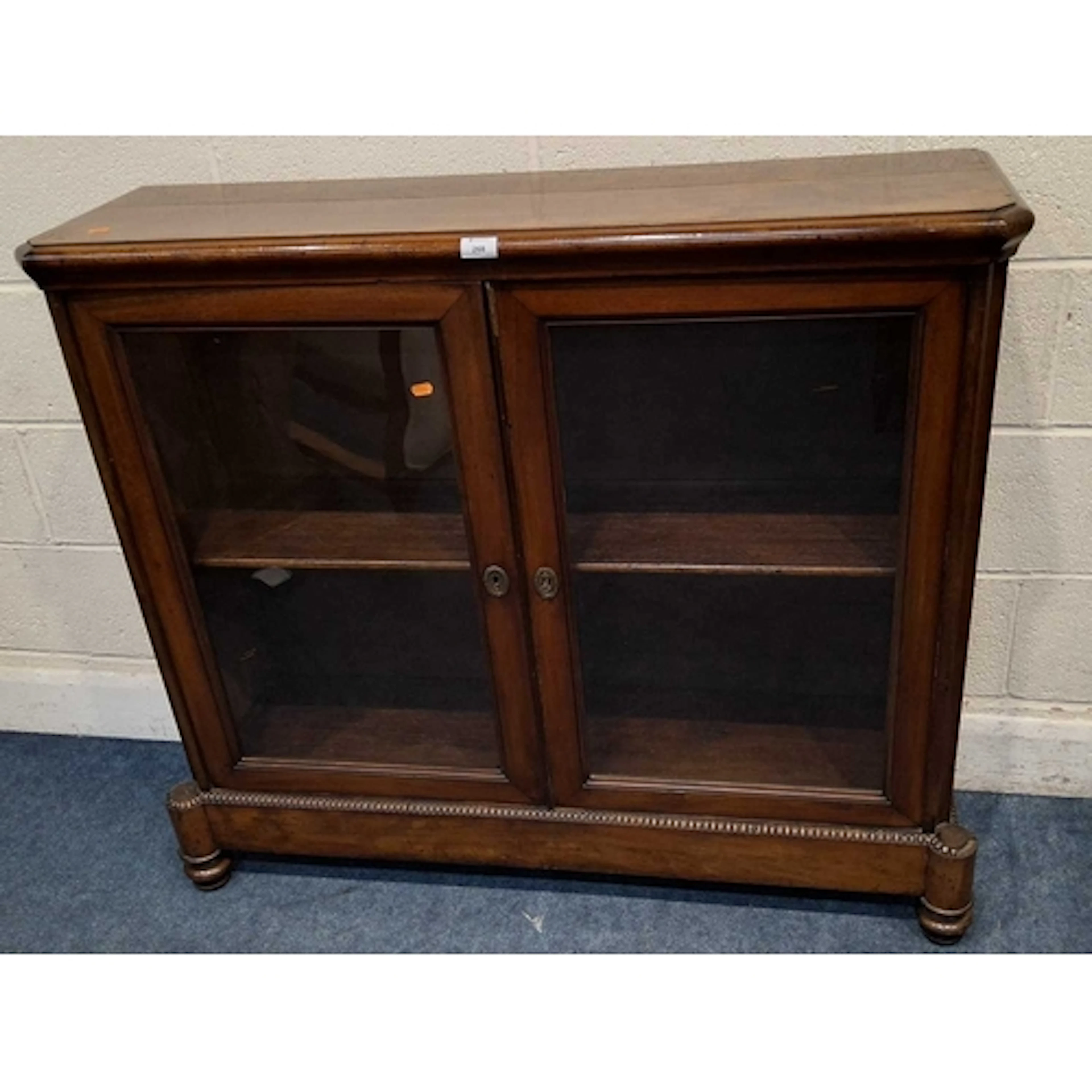 A VICTORIAN MAHOGANY BOOKCASE, the double glass doors enclos...