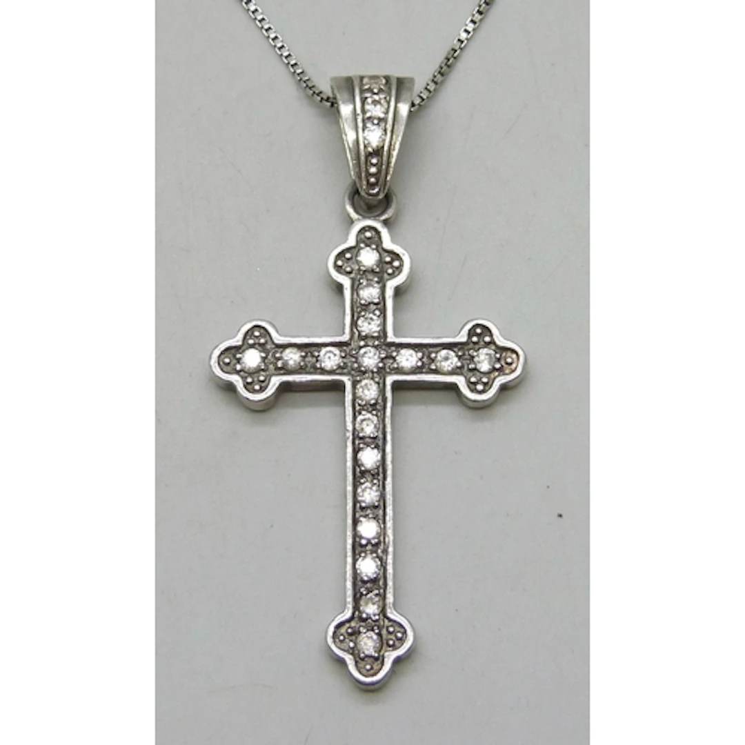 A silver cross pendant on a silver box link necklace chain, ...