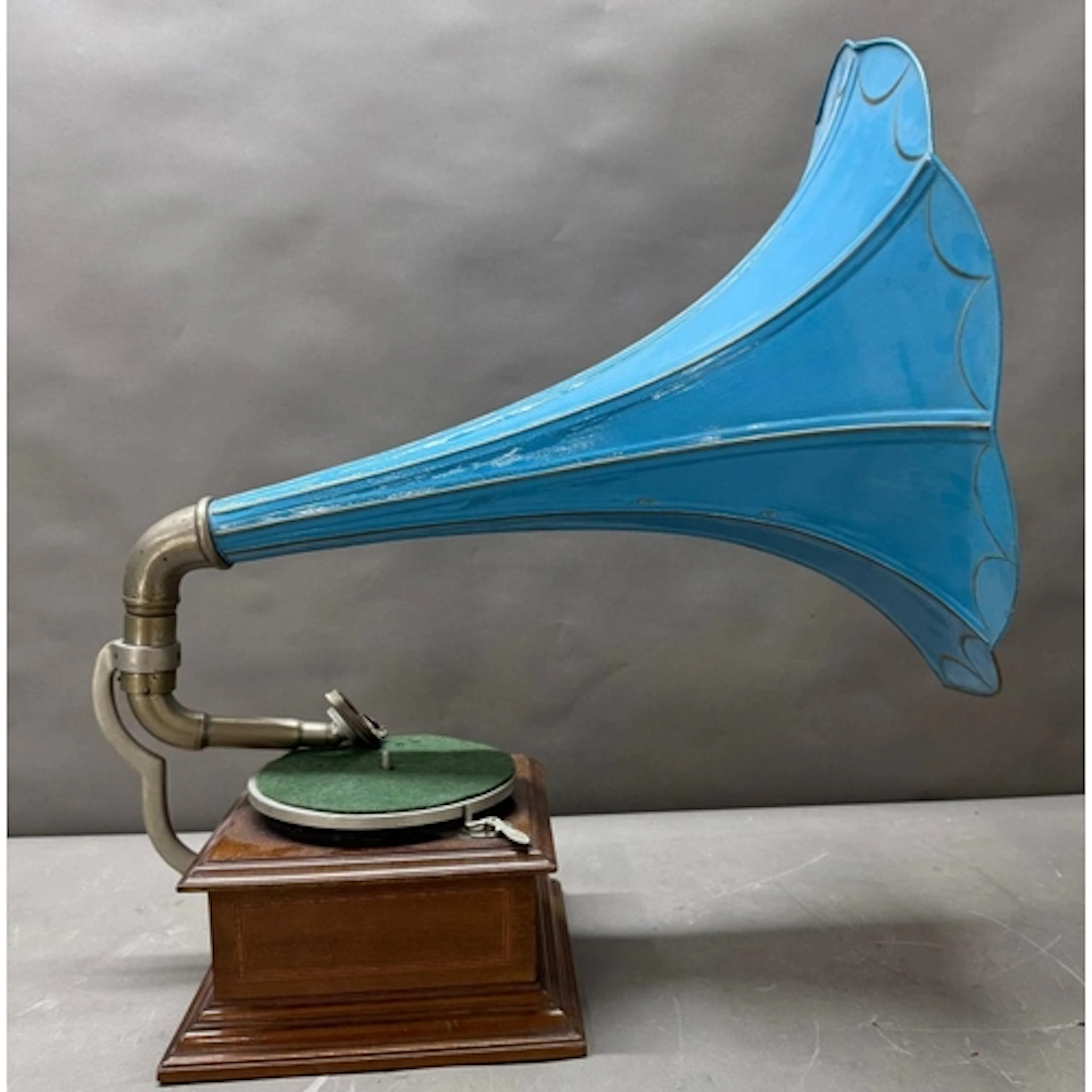 A vintage Apollo gramophone with a light blue painted trumpe...