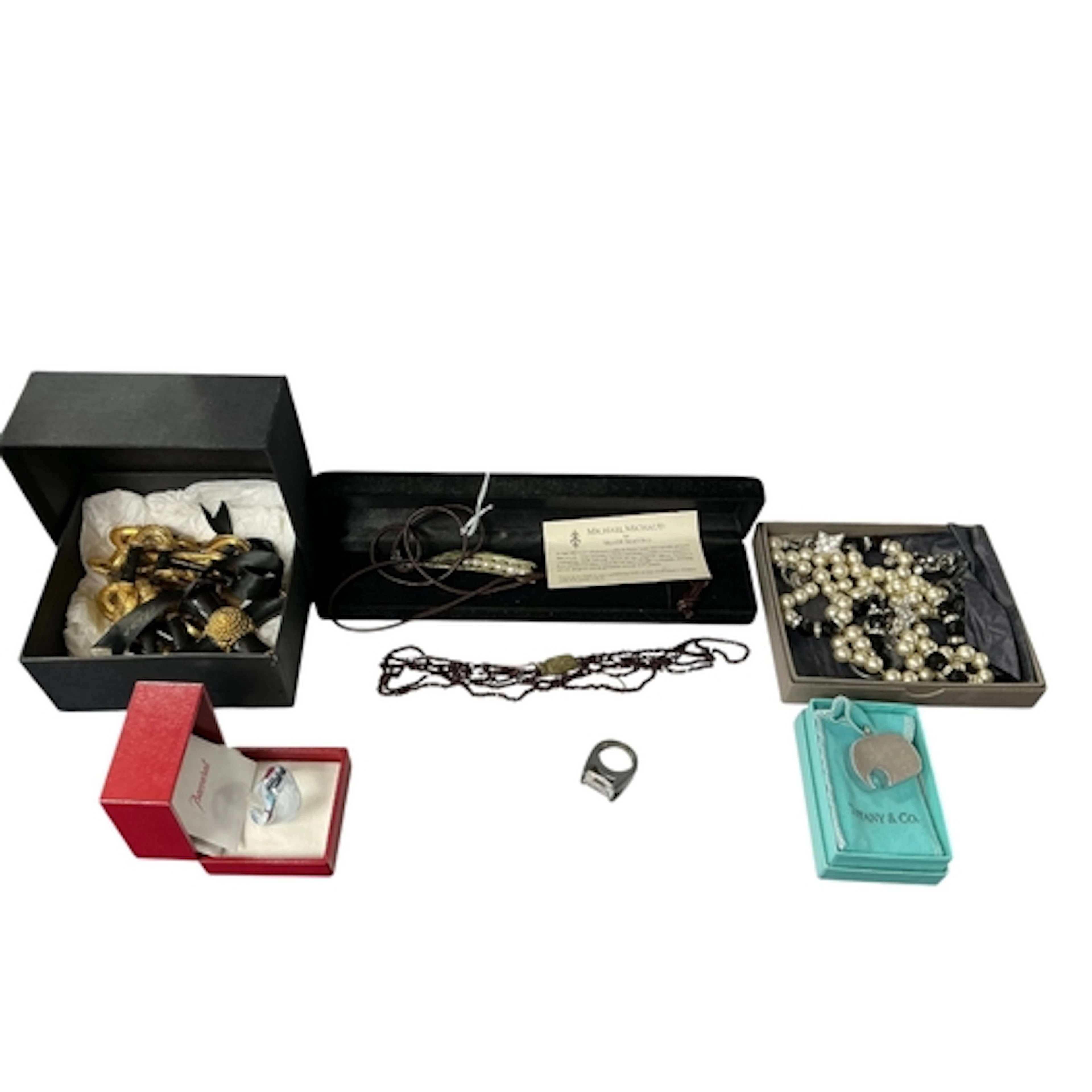 A collection of costume jewels, comprising: a black enamel a...