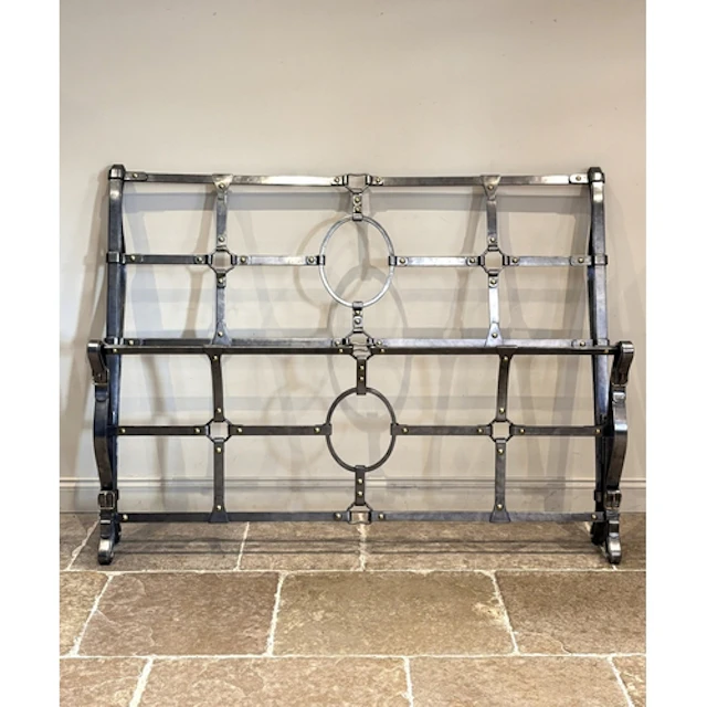 A wrought iron super king size bed, designed as strap work w...