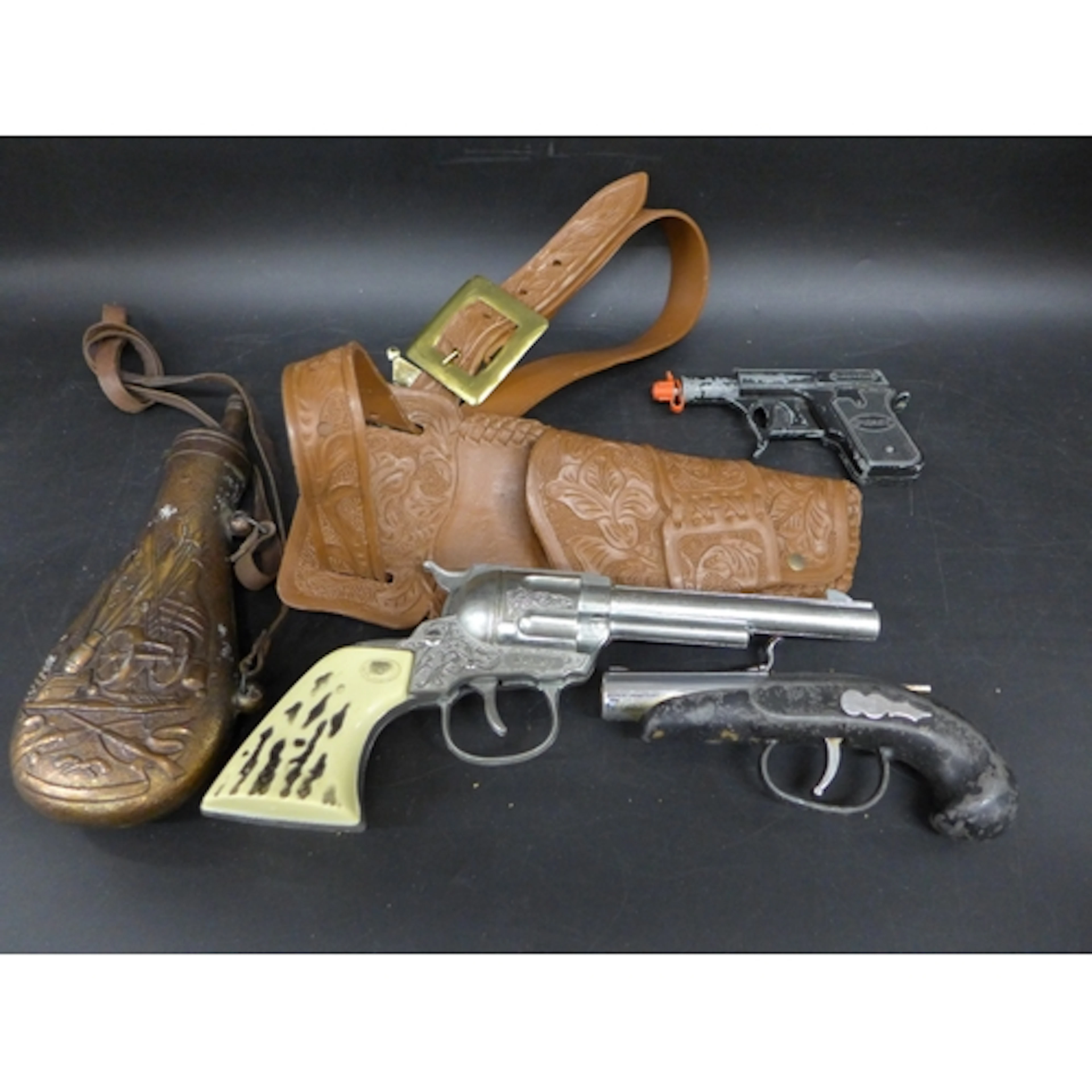 A collection of toy guns including a Daisy gun with holster ...