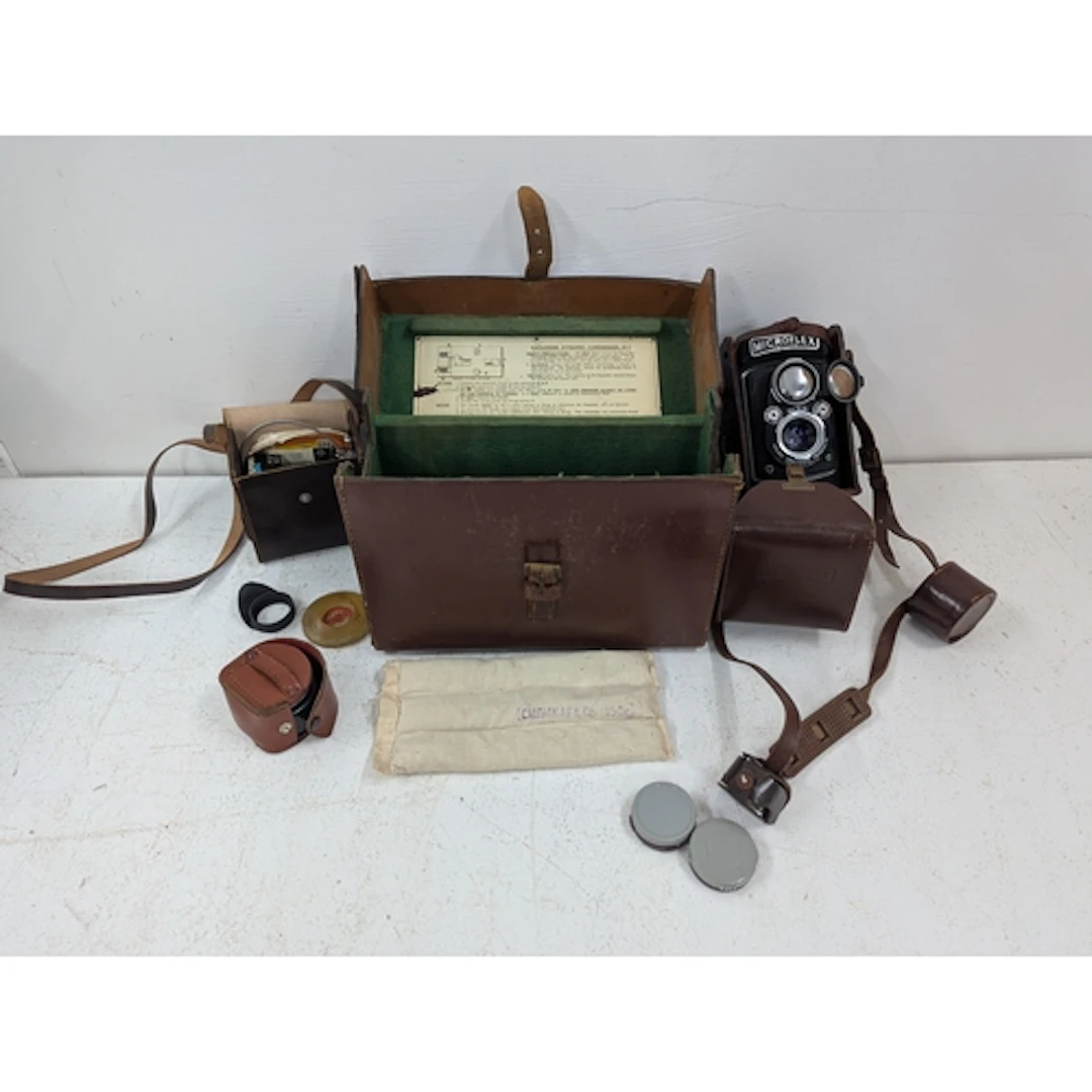 A Microflex MPP twin lens camera, with accessories in a leat...