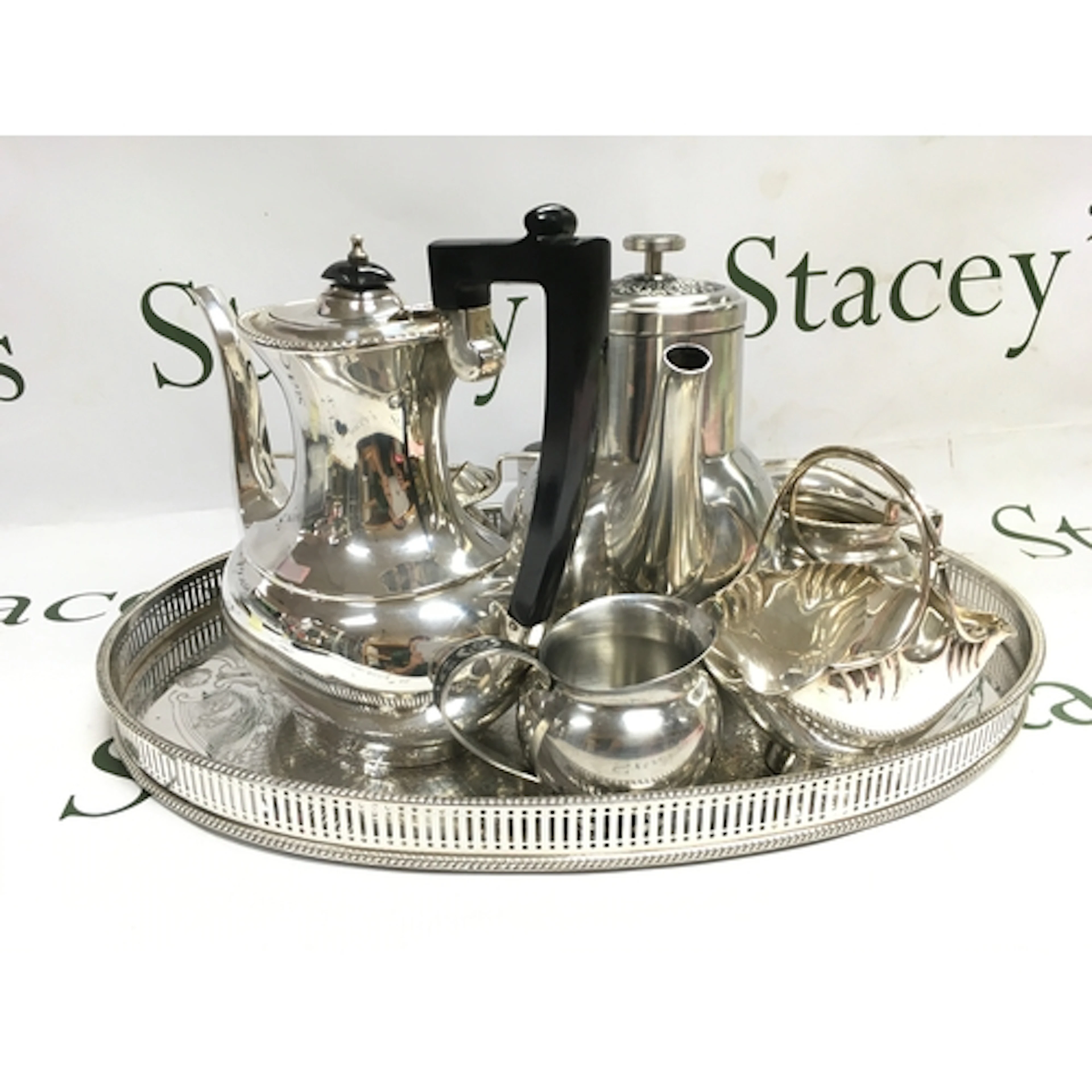 A silver plated tea set, a tray basket (46cm wide), coffee p...