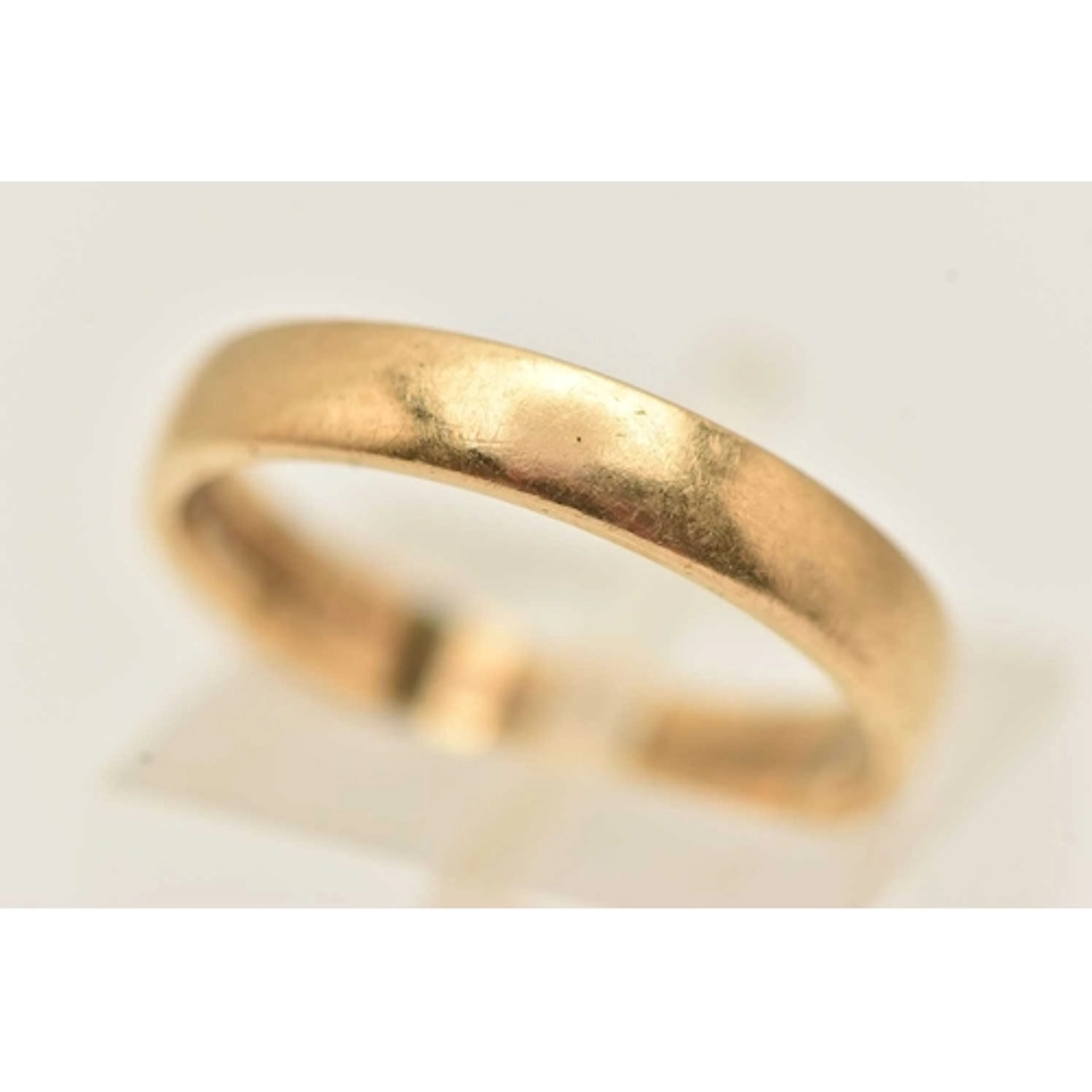 AN 18CT YELLOW GOLD BAND RING, of plain polished design, hal...