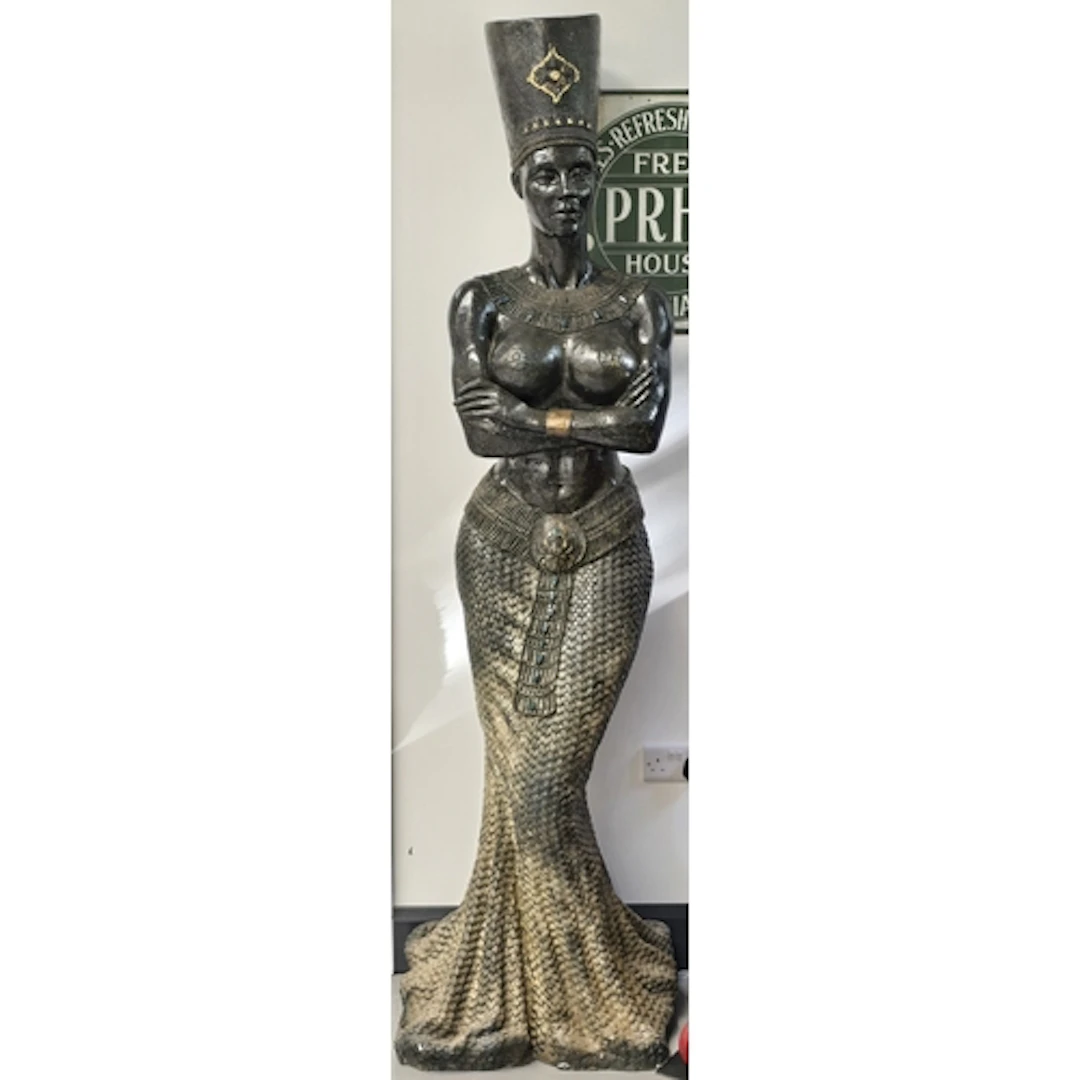 A large decorative floor statue in an Egyptian revival style...