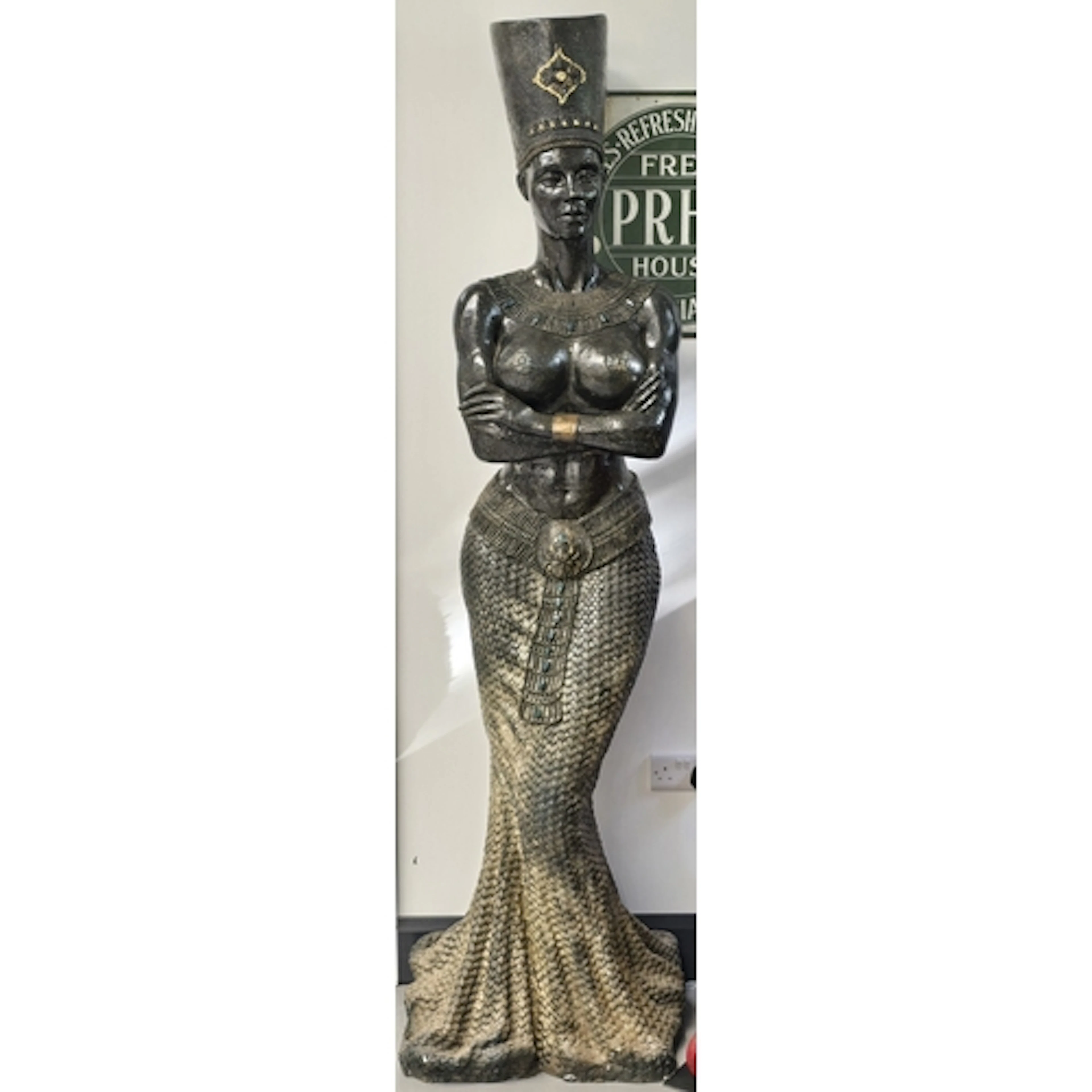 A large decorative floor statue in an Egyptian revival style...