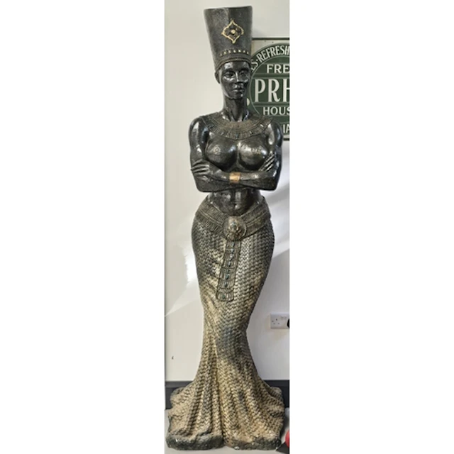 A large decorative floor statue in an Egyptian revival style...