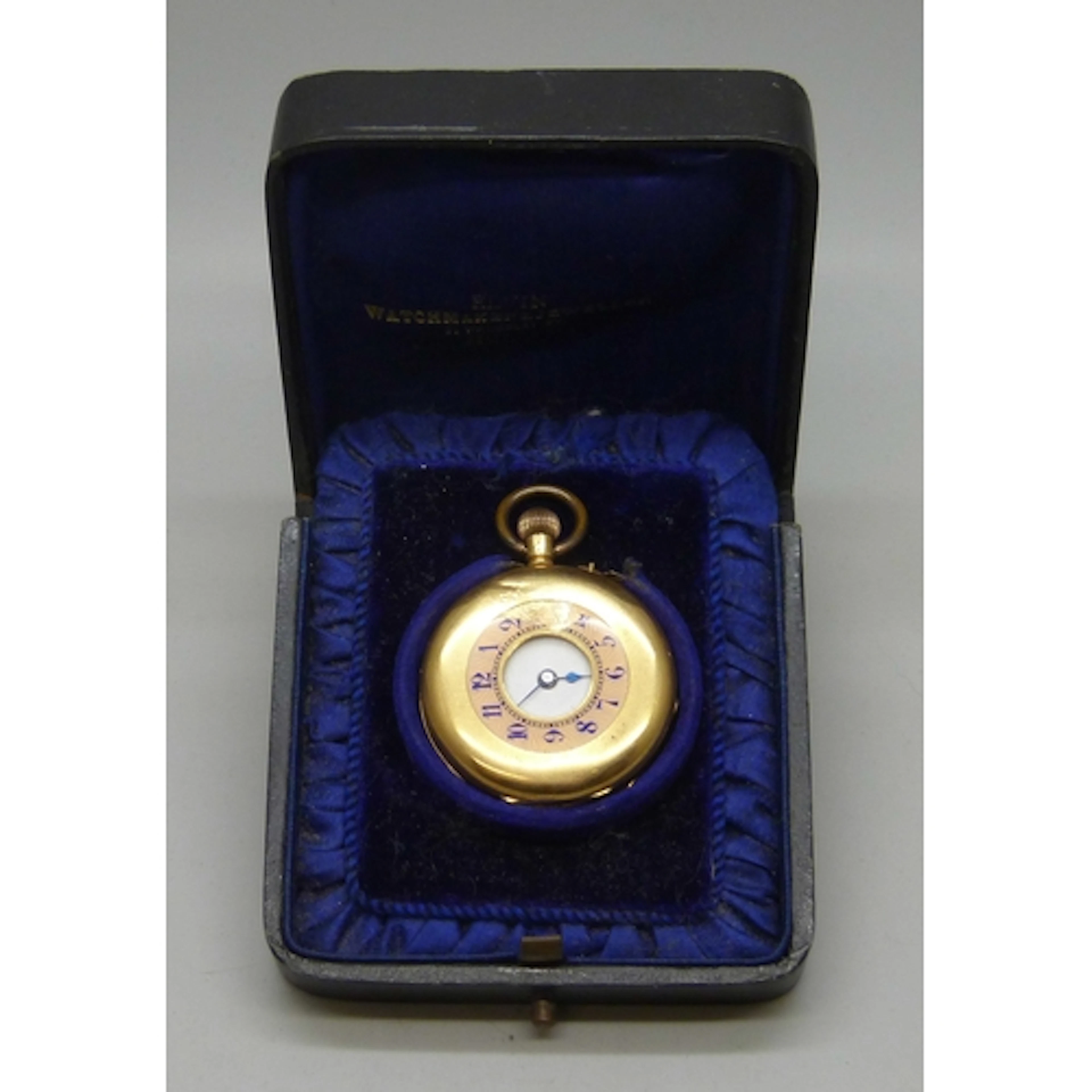 An 18k gold cased half hunter fob watch with enamel numerals...