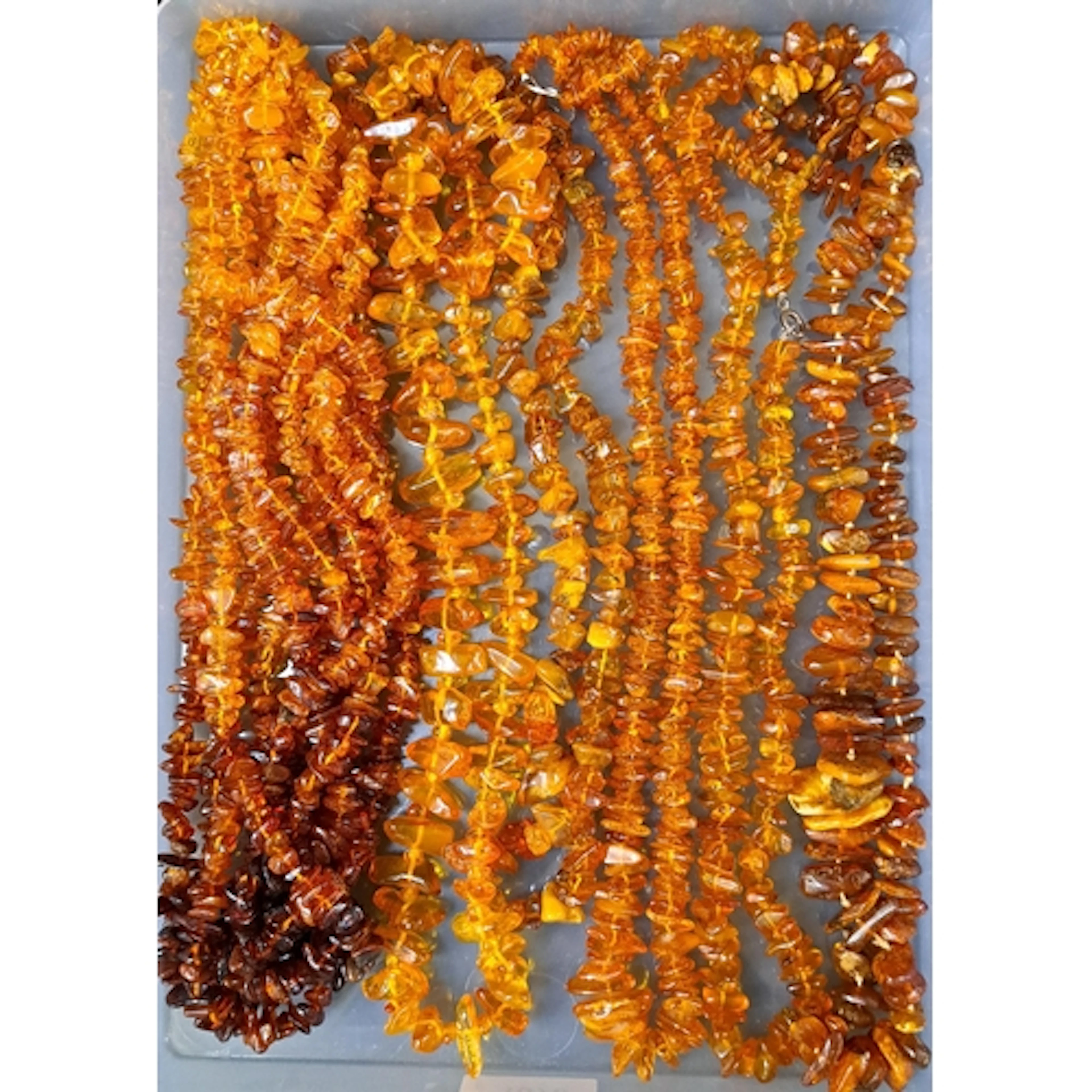 SELECTION OF AMBER AND AMBER COLOURED BEAD NECKLACES includi...