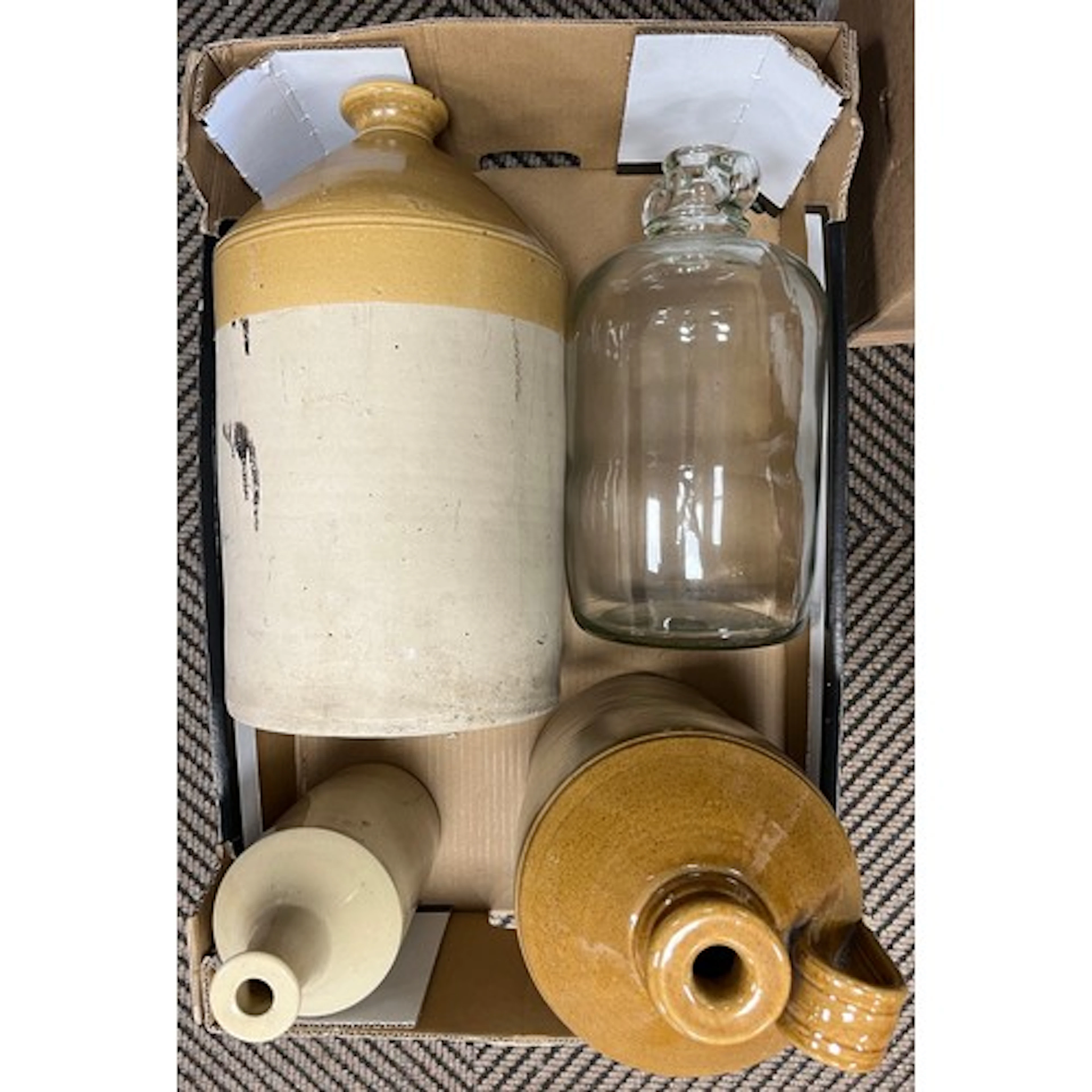 Three stoneware jugs and a demi john. (4)