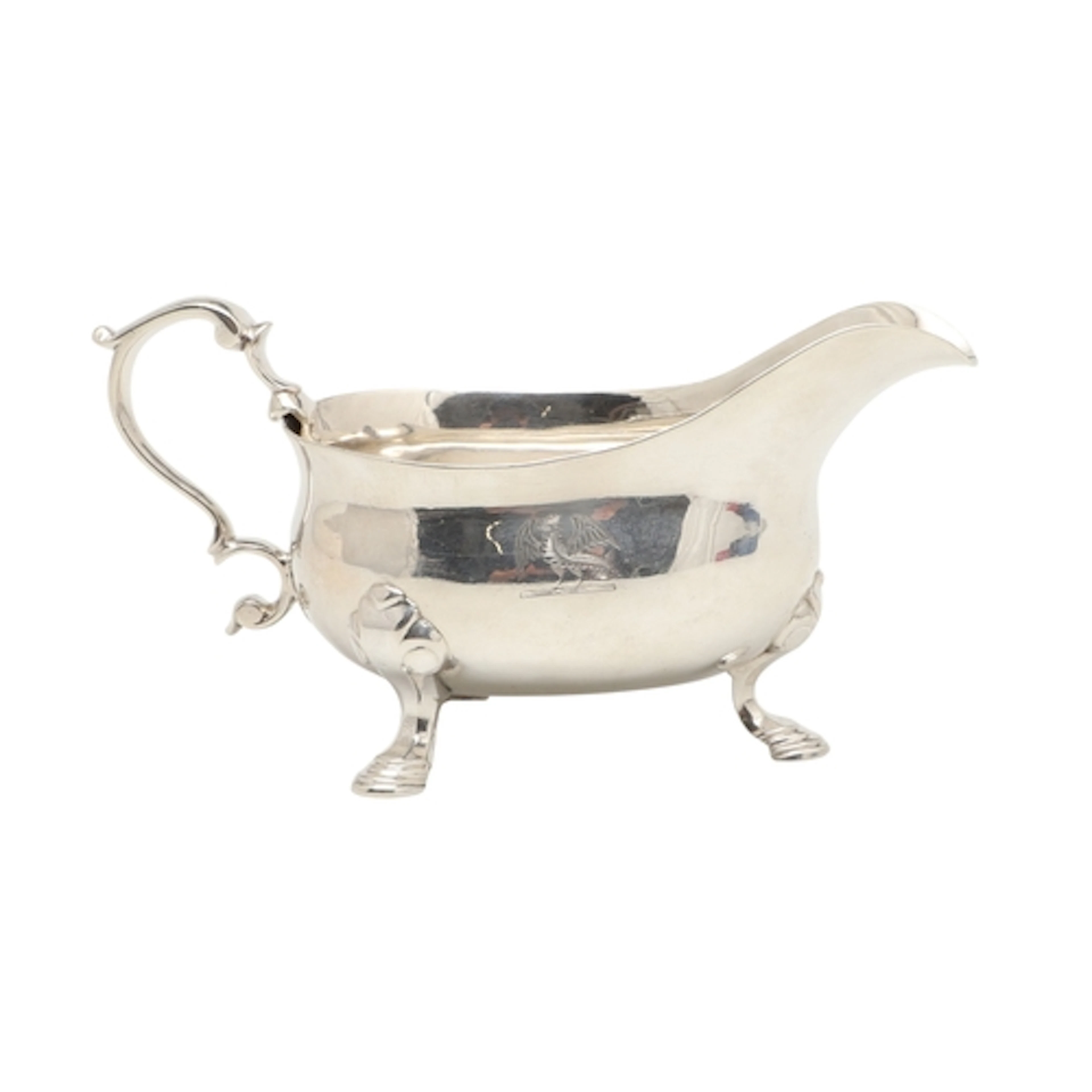 A GEORGE II SMALL SILVER SAUCE BOAT. Engraved with a crest, ...