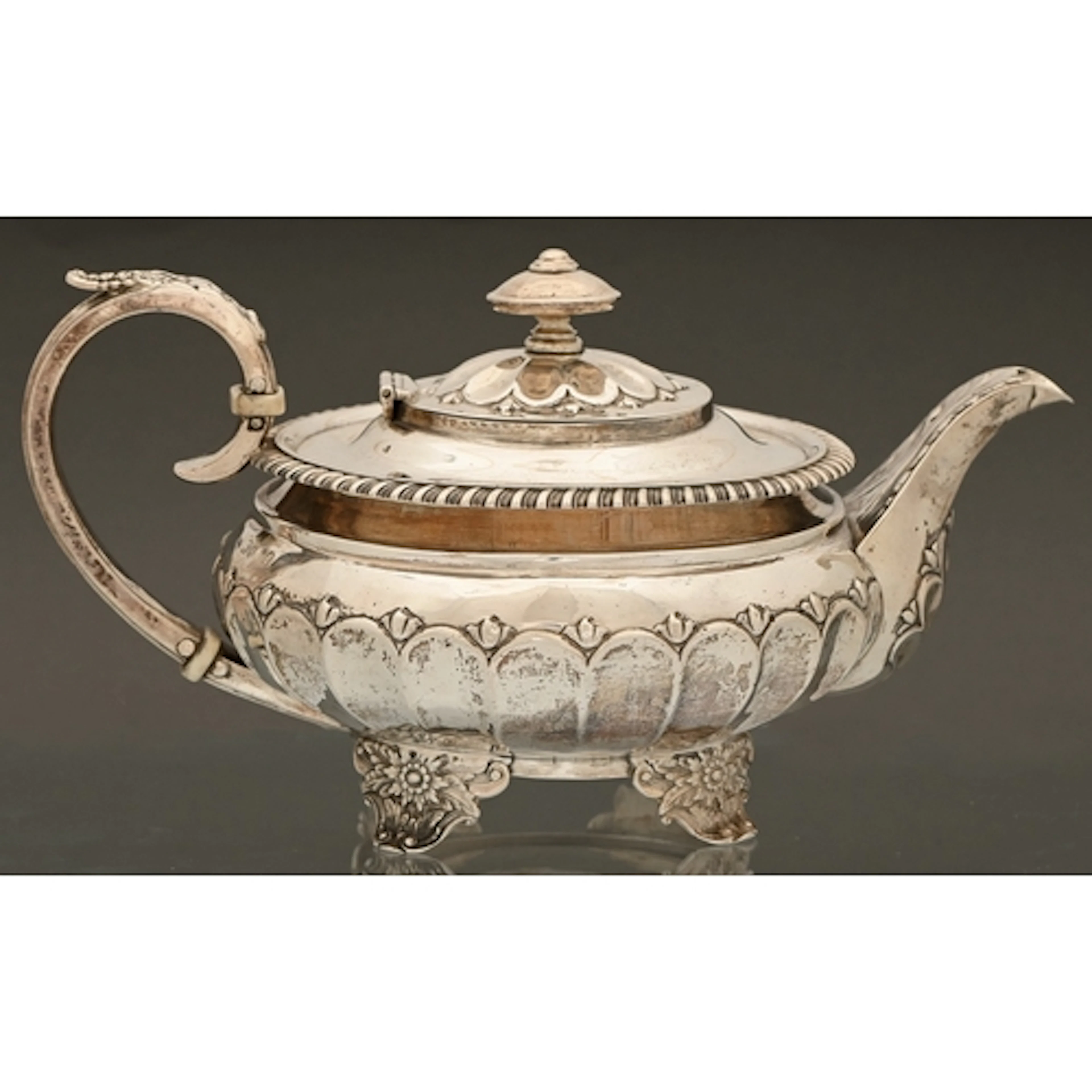 A George IV silver teapot, with gadrooned rim and fluted lid...