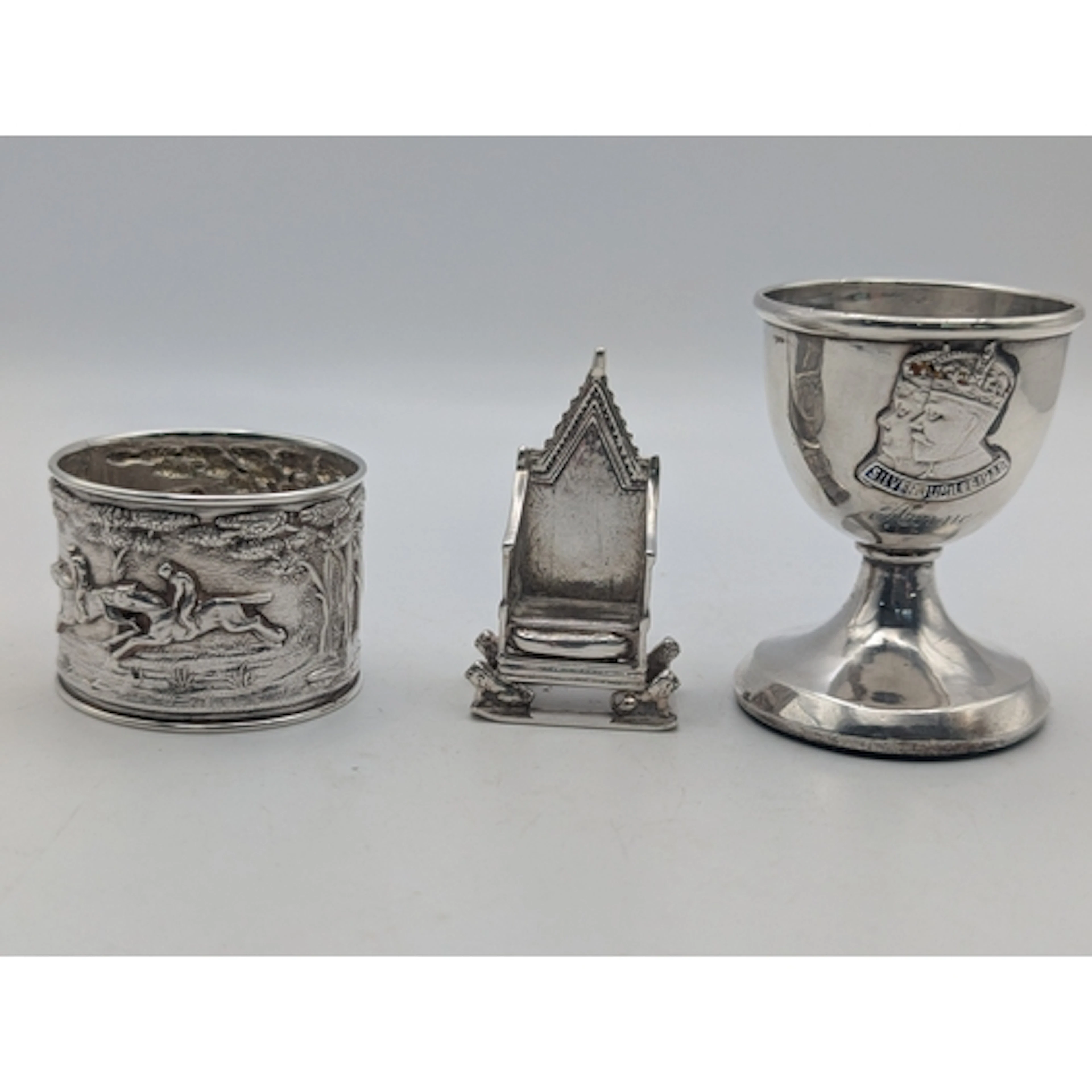 Silver to include a Coronation chair, a decorative napkin ri...