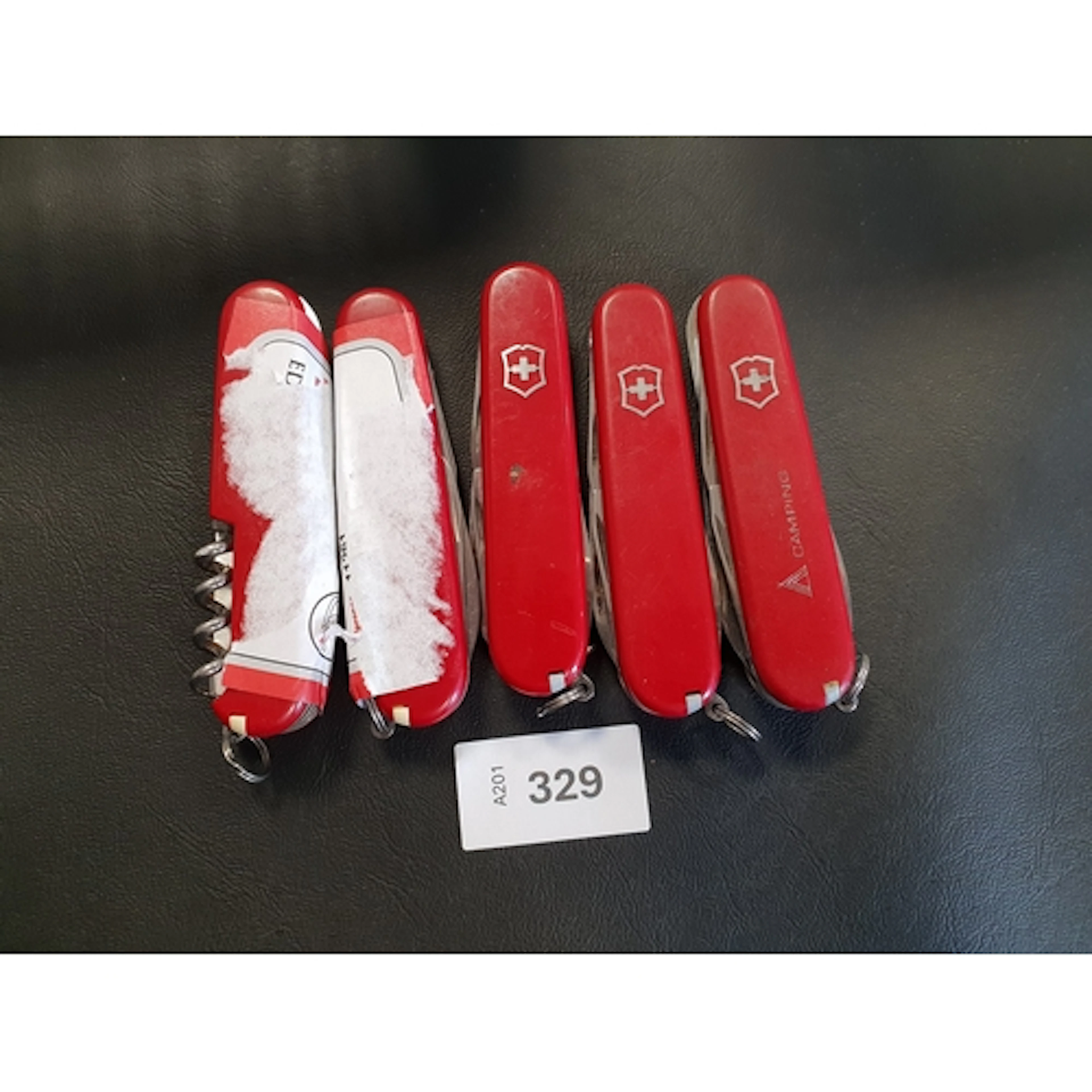 FIVE VICTORINOX SWISS ARMY KNIVES of various sizes and desig...