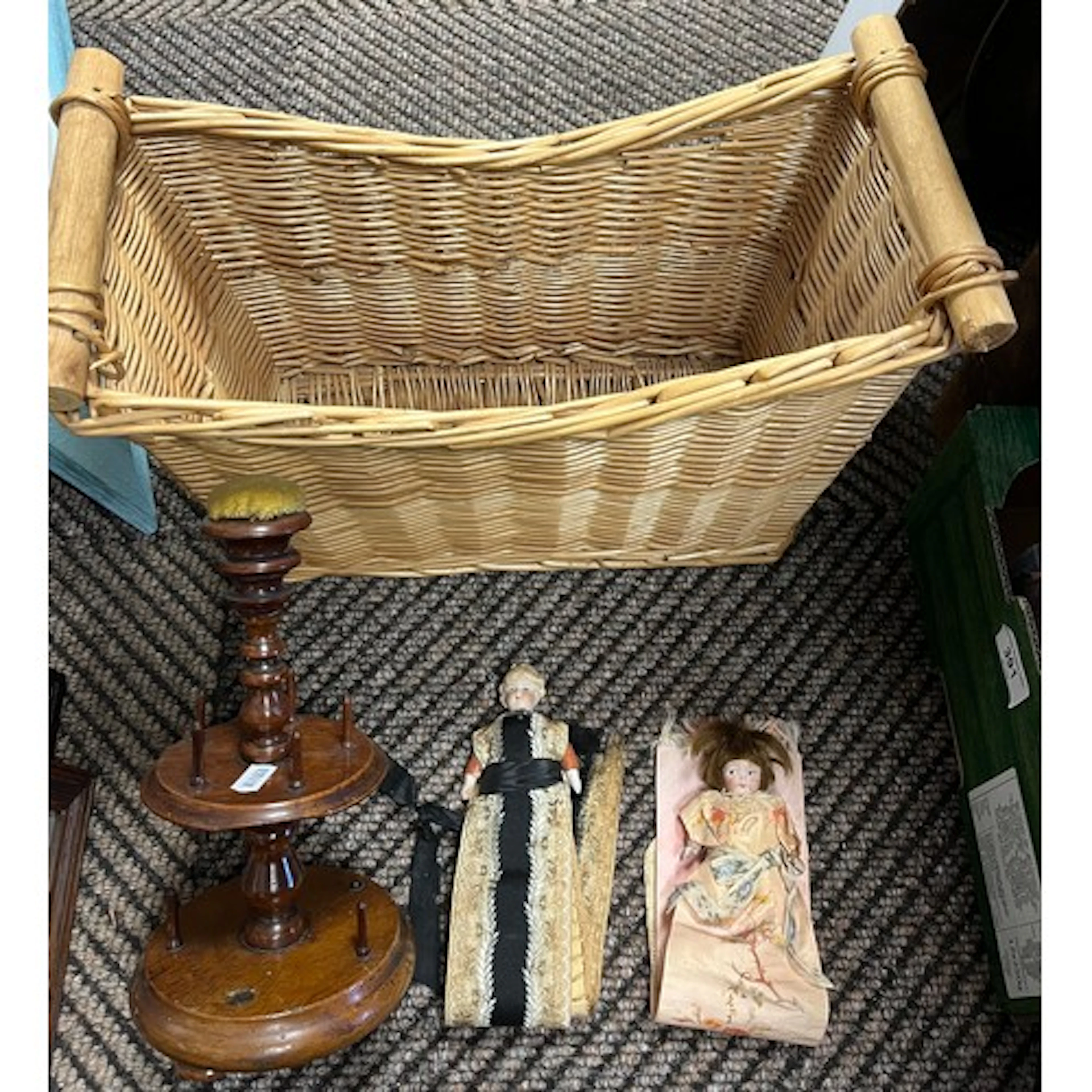 Wicker basket containing antique bobbin holder and vintage d...