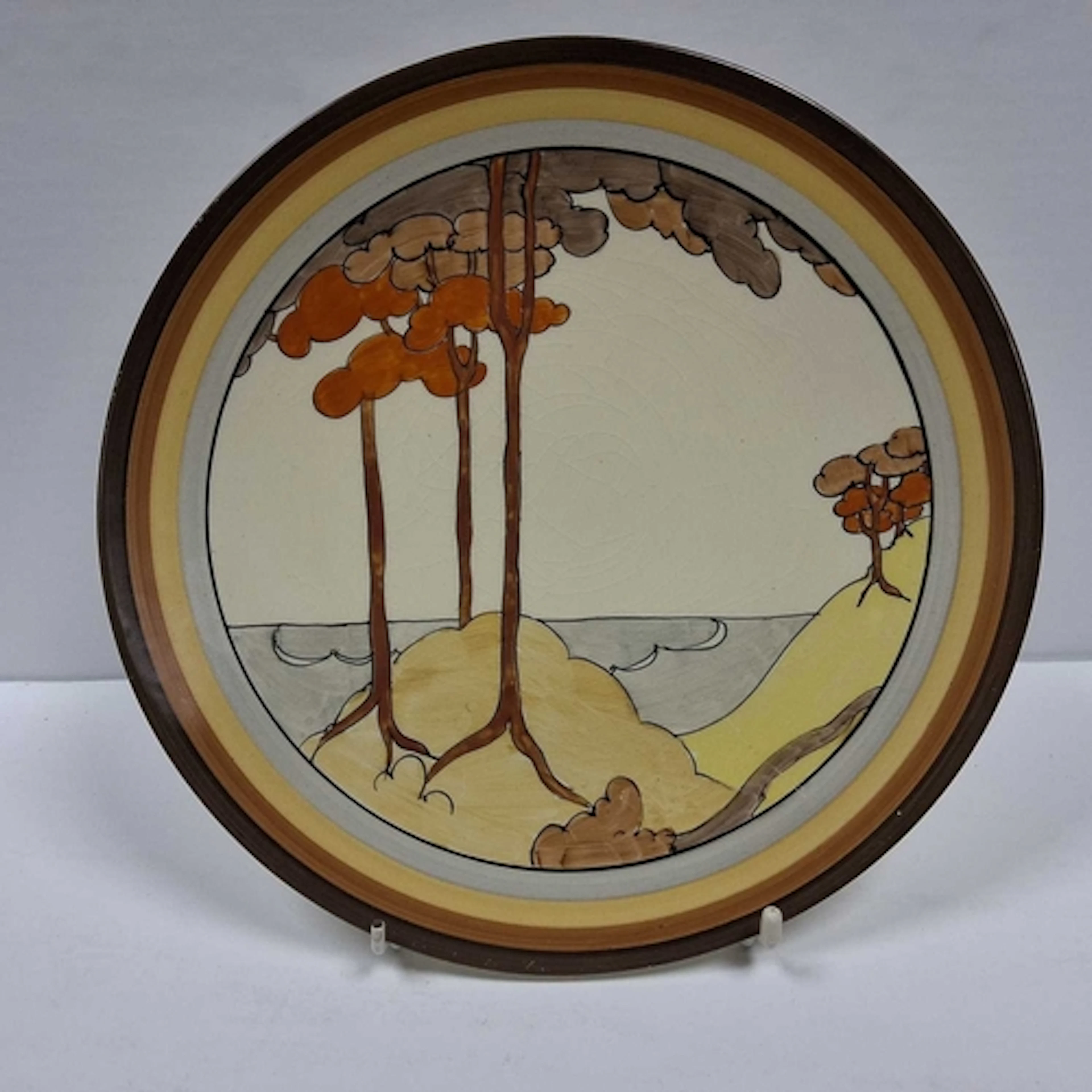 HAND-PAINTED BIZARRE BY CLARICE CLIFF PLATE, featuring the a...