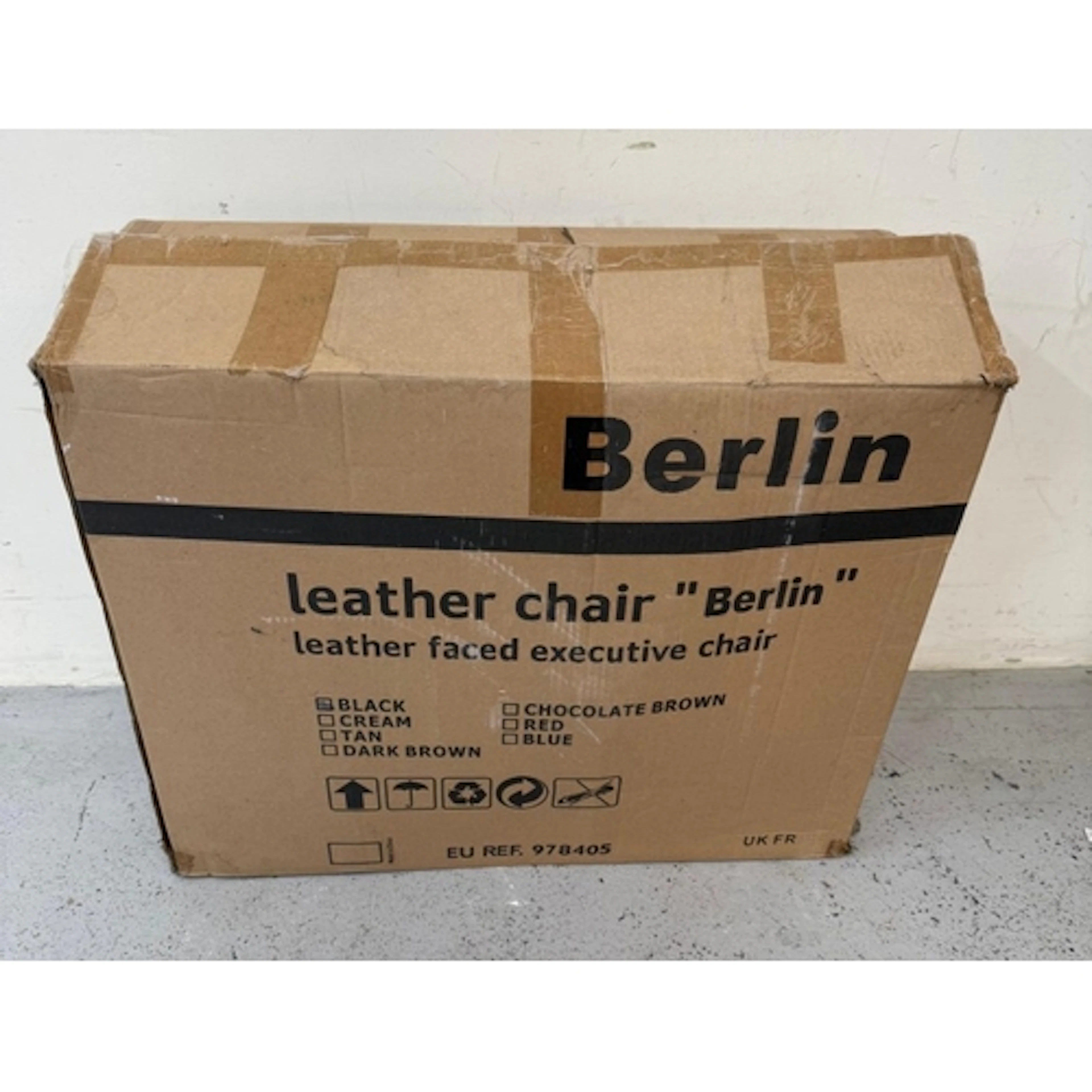 A boxed Berlin black leather executive chair