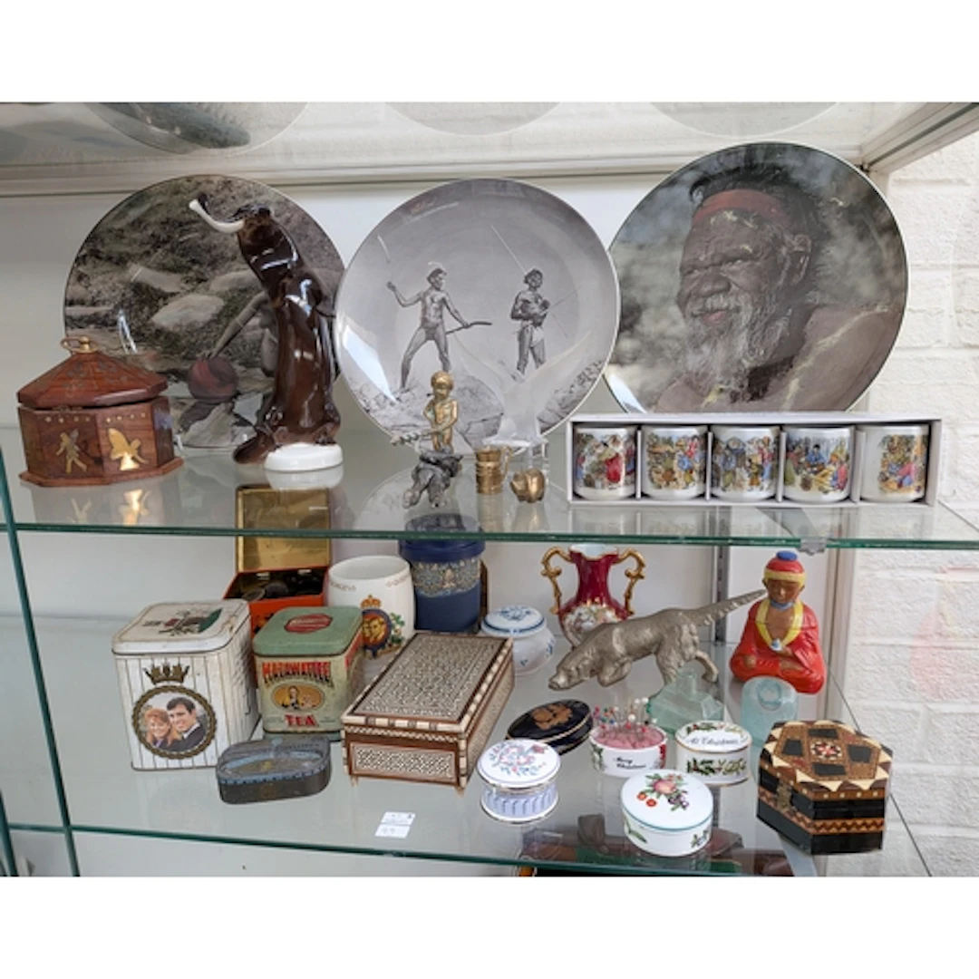 Collectables on two shelves - to include three African scene...